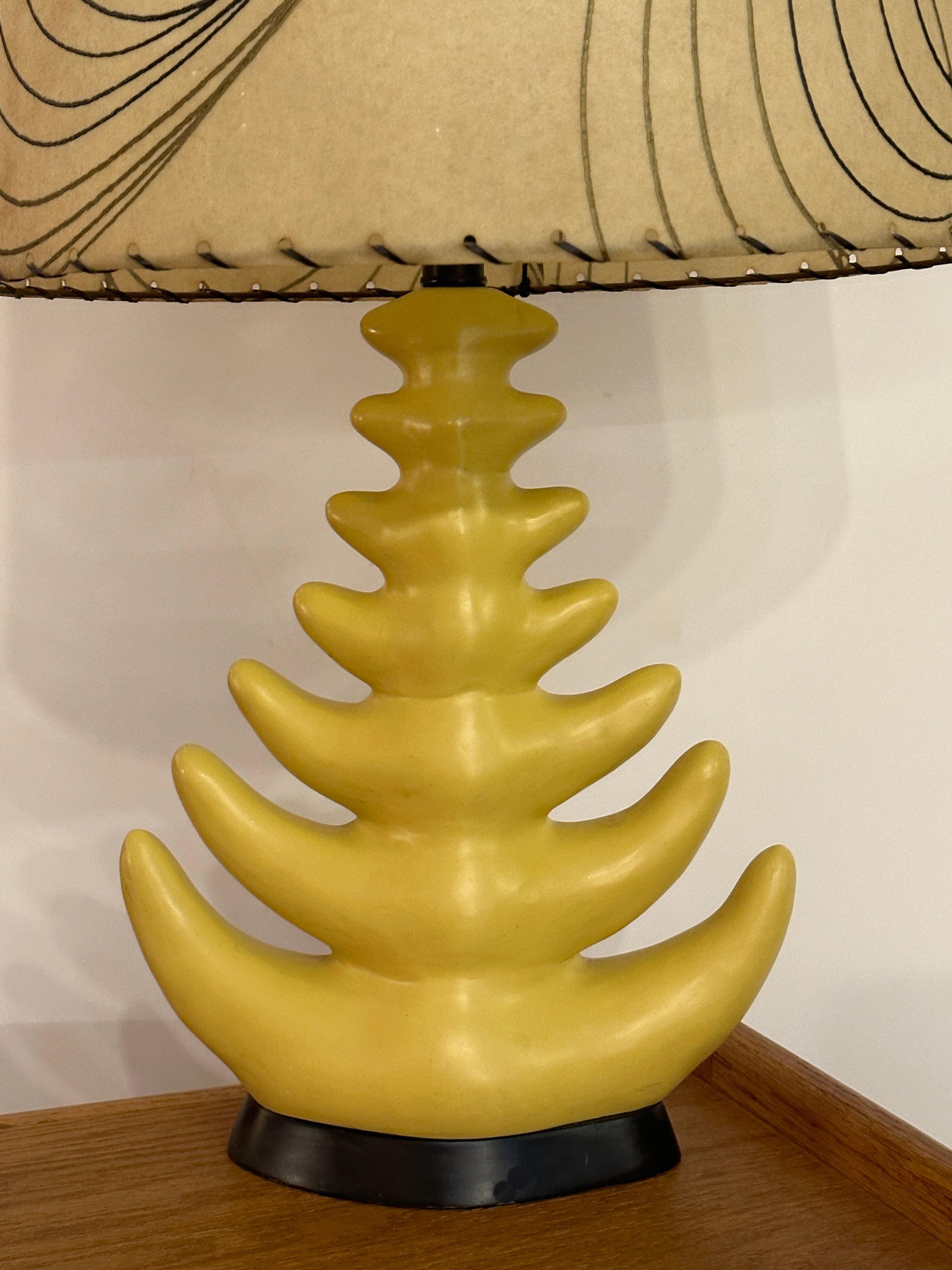 This Mid-Century yellow ceramic lamp with 6 Branches stands on a  black wood base. The six ceramic yellow branches gracefully curve upwards, capturing the essence of mid-century design and adding an elegant touch to its overall form.

The lamp's