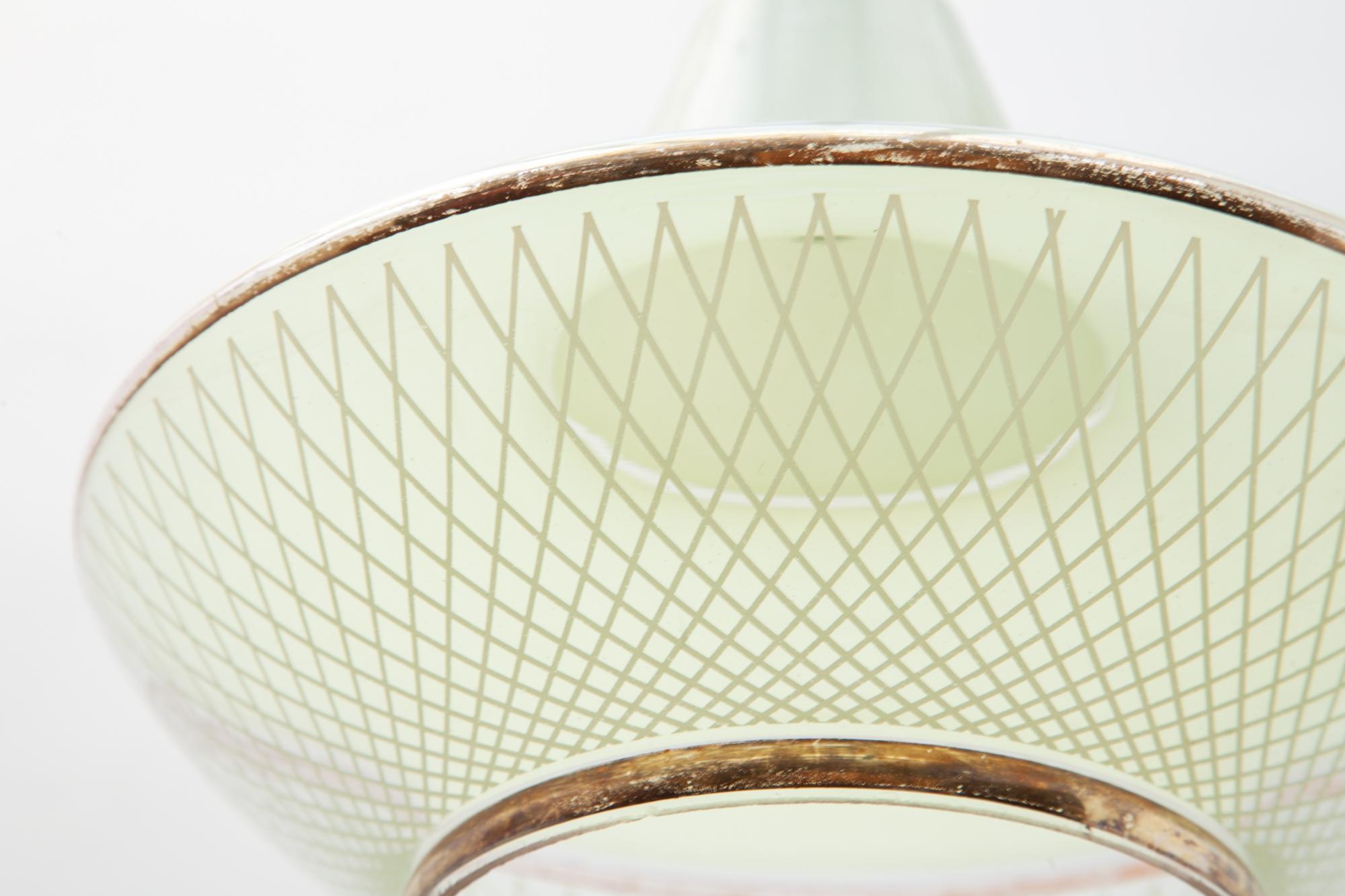 Midcentury pendant light. Made of glass with enamel painted design in pastel yellow with gold accents made by the Belgium glass manufacture Boom.