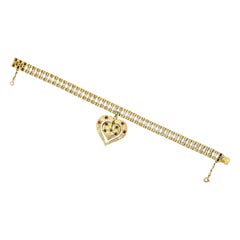 Mid-Century Yellow Gold Bracelet with an Articulated Double Sided Gem Heart Char