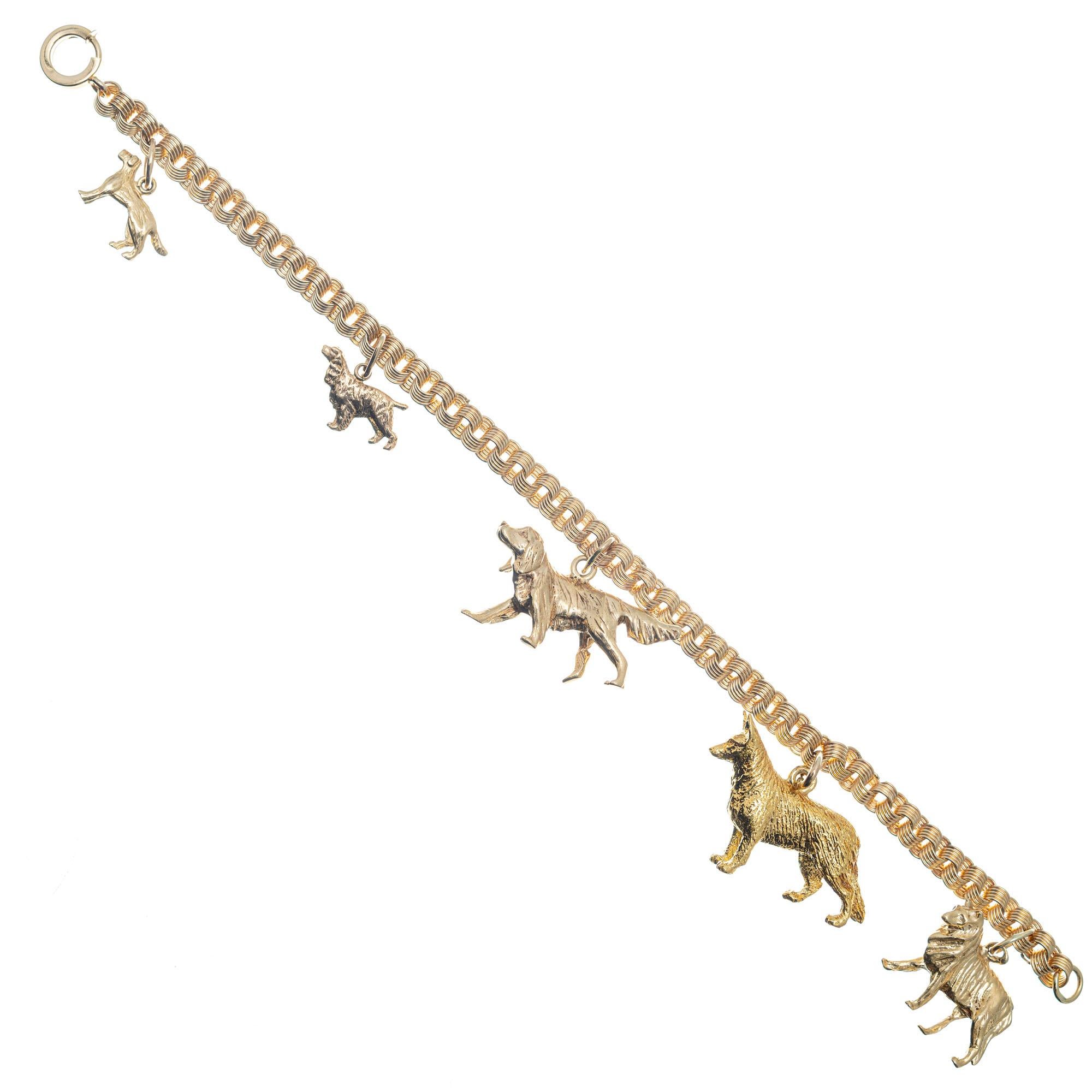 Vintage 1960's handmade triple spiral link 14k yellow gold charm bracelet with five detailed dog charms; retriever, setter, shepherd, collie. 7.5 inches in length. 

14k yellow gold 
Stamped: 14k
34 grams
Total length: 7.5 Inches