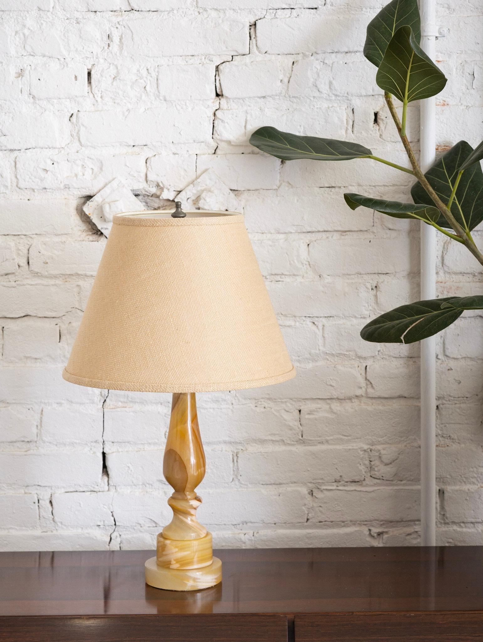 A petite table lamp in yellow onyx. Solid stone. Harp and finial included. Shade not included. Measurements show length from base to top of finial.