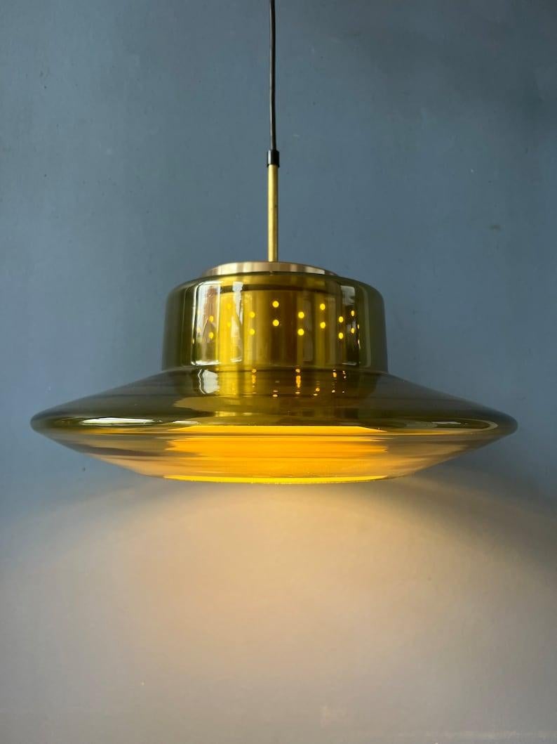 Mid century UFO space age pendant light with a smoked glass shade by Dijkstra. The lamp consists of a glass outer shade and aluminium inner shade. Together they produce a magnificent space age light. The lamp requires one E27/26