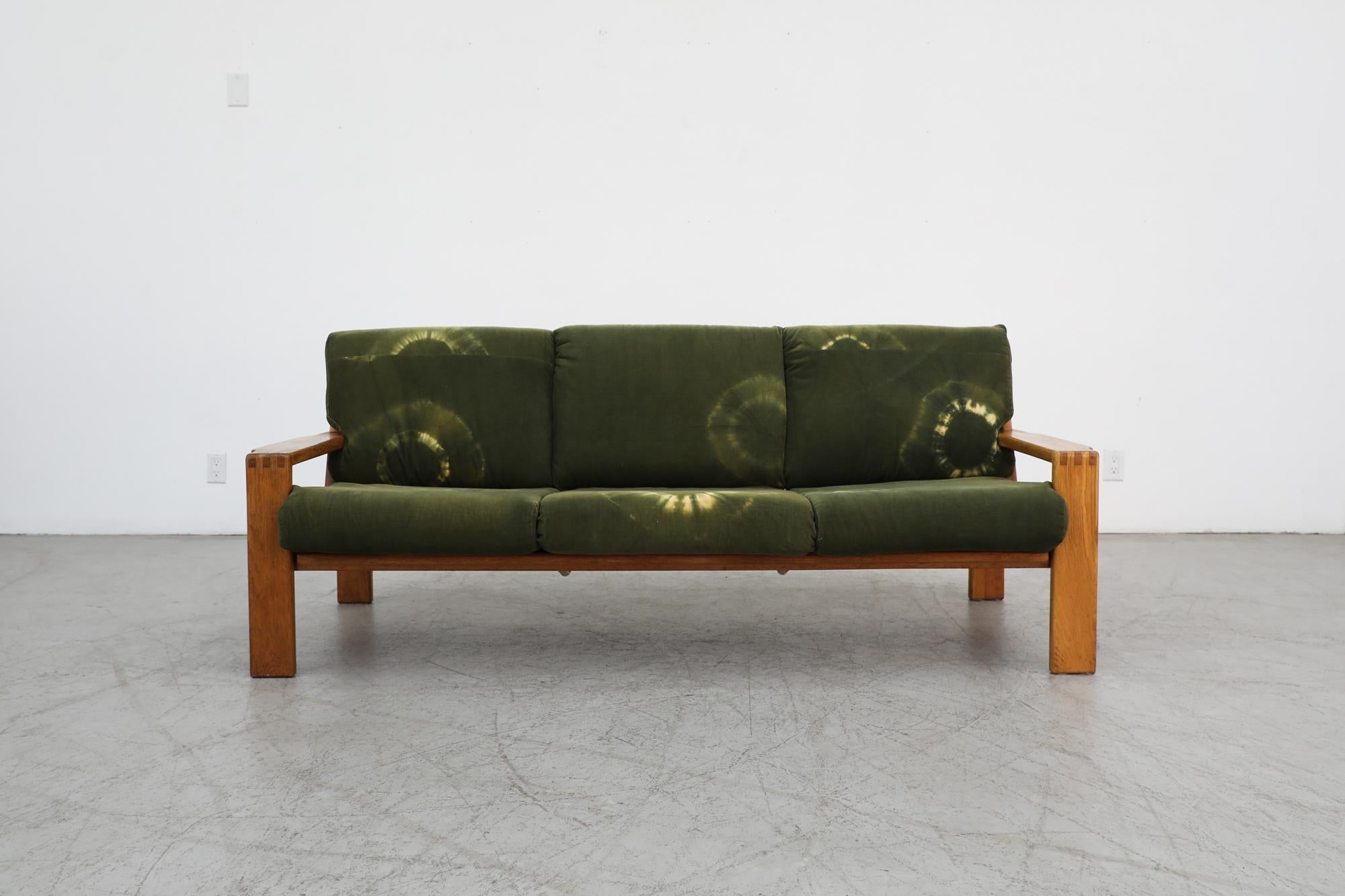 Mid-century Swedish oak three seater sofa with eye-catching  green tie dye cushions. The oak frame is in original condition with wear and nice patina. Tie-dye cushions are not original and have some visible sun fading resulting in an imprint of the