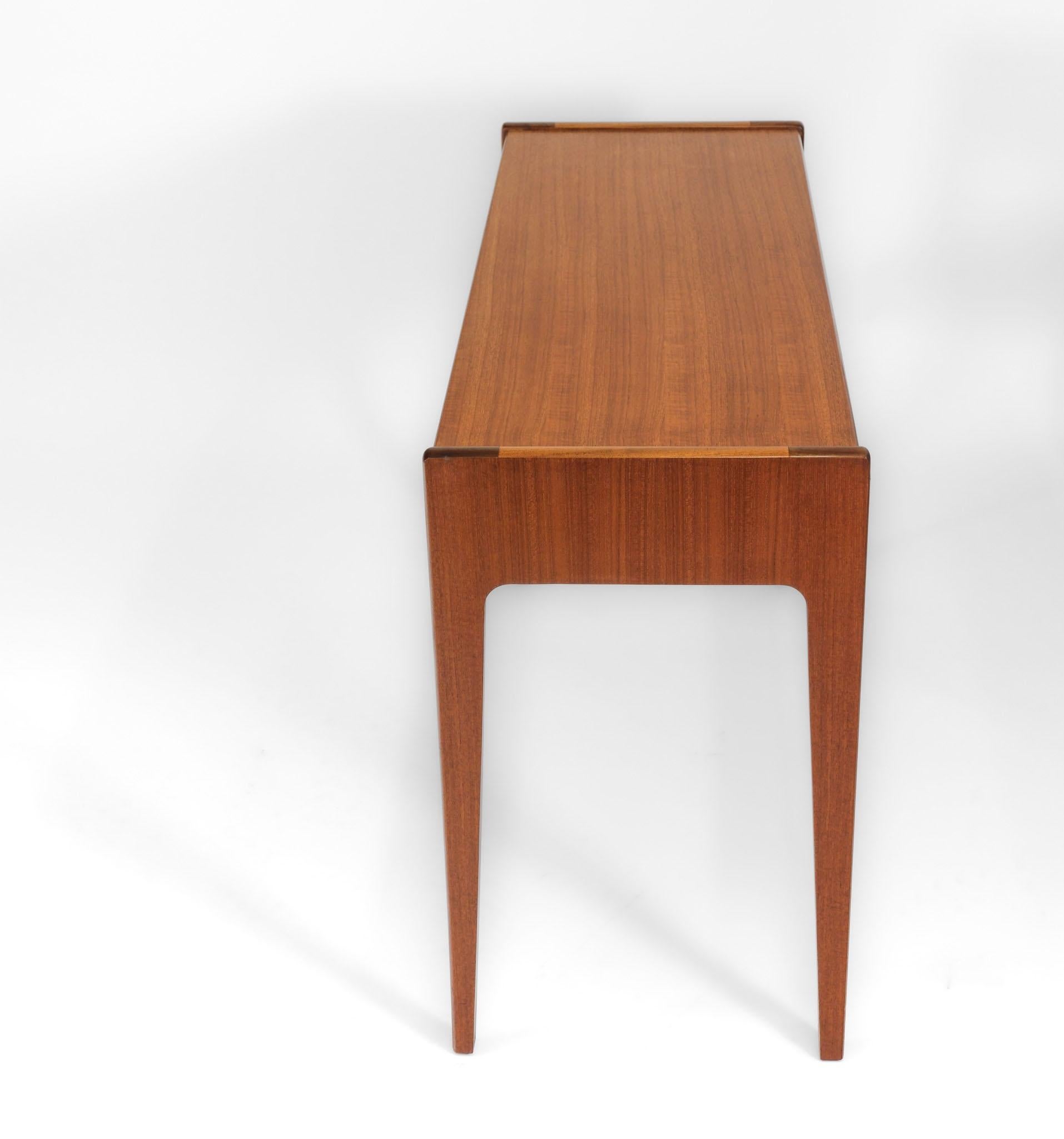 A sleek mid century teak console table by Younger. Maker's label. Circa 1960.

A scarce design from this company, the table is in excellent clean condition. There are a few light marks to the front edge to note, please refer to photograph number 12.