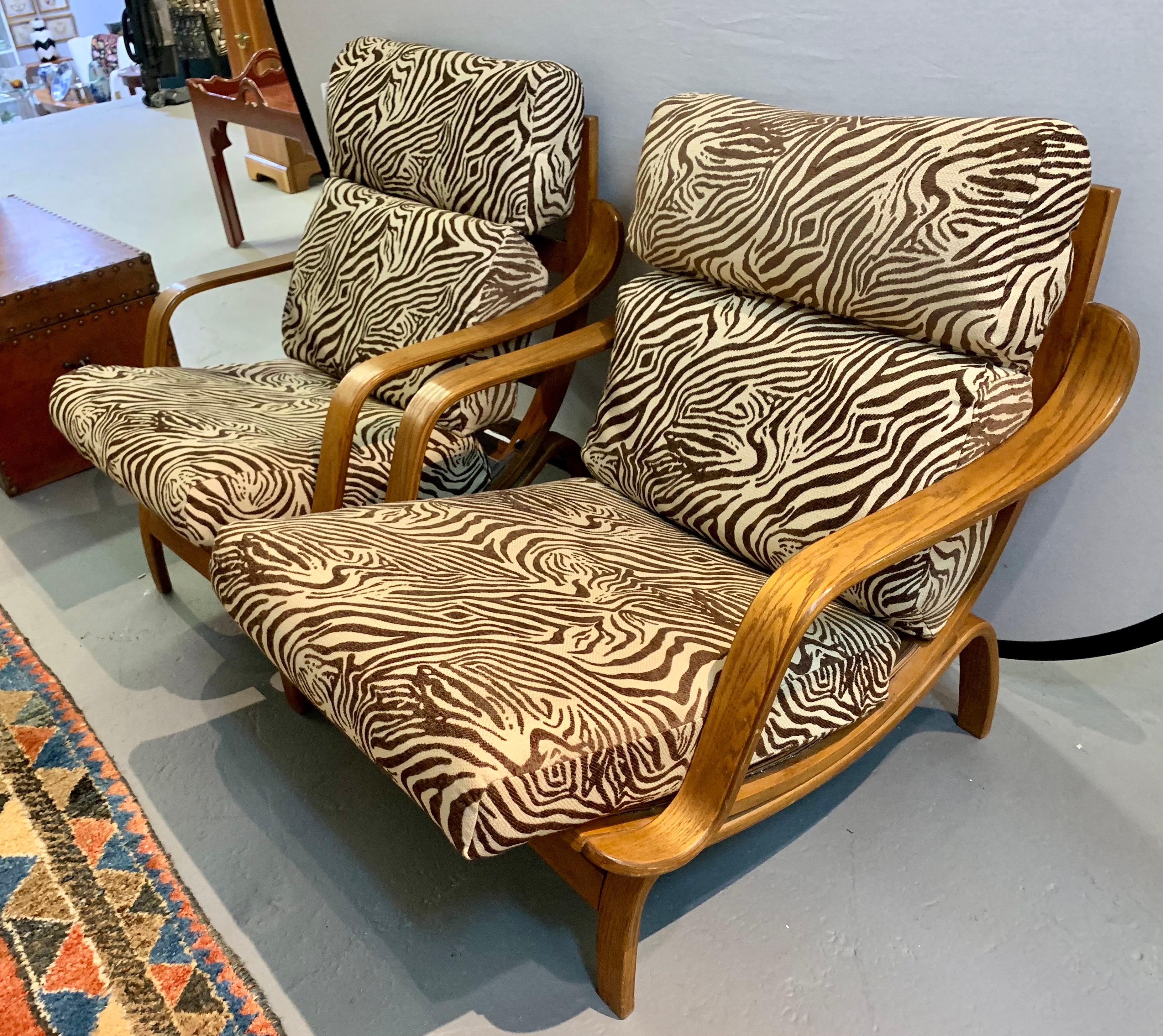 Mid century vintage bentwood lounge chairs with arched legs that create a cradle for the chair body. The seat appears to float within the cradle base. Cushions have been newly upholstered in a zebra print fabric.