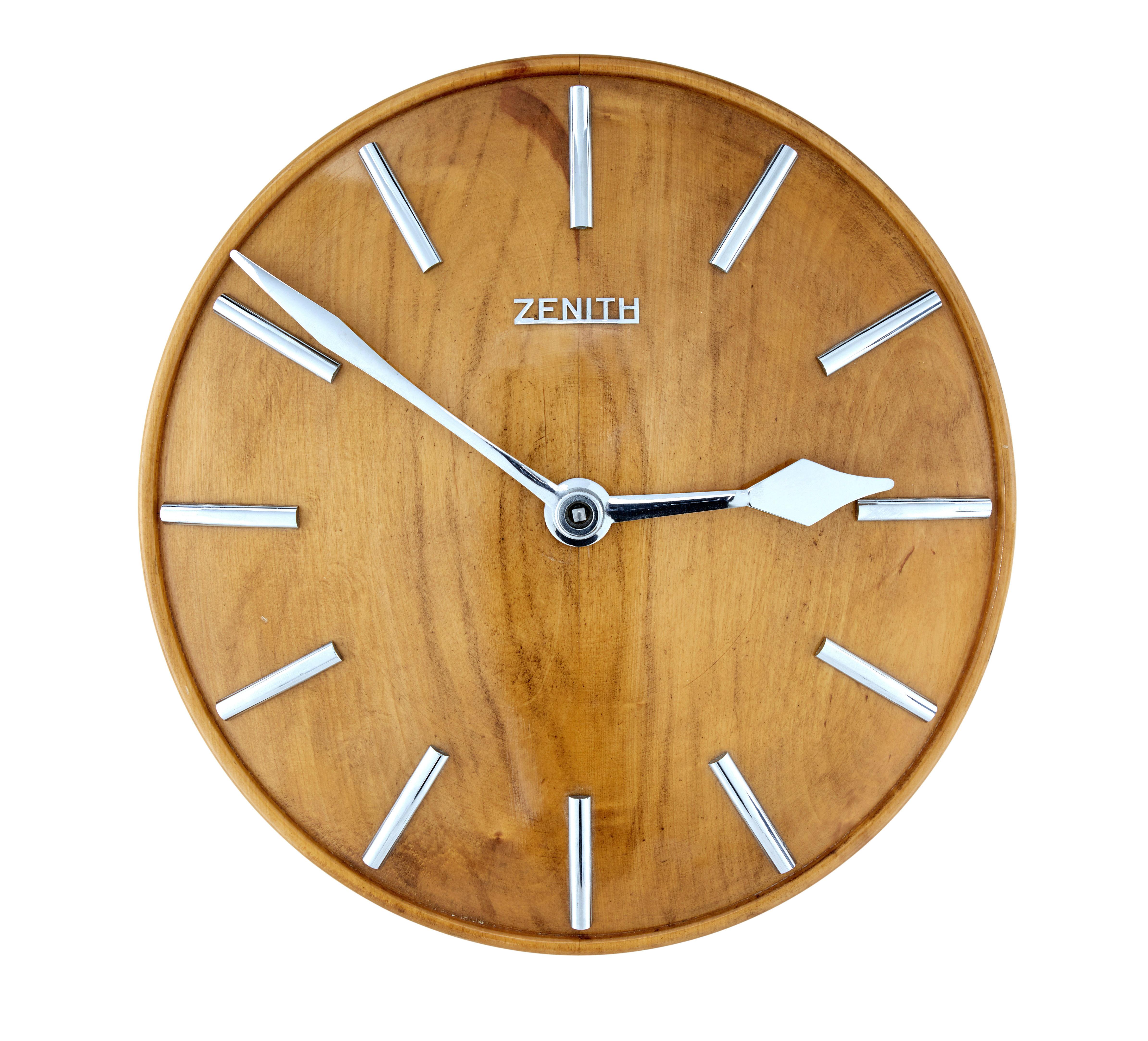 Mid-century zenith oak wall clock, circa 1940 - 1950.

Fine example of a convex shaped wall clock, by the well known maker zenith.  Popular for retailing out of heals of London during the 1930's.

This example has silvered hands and marks to