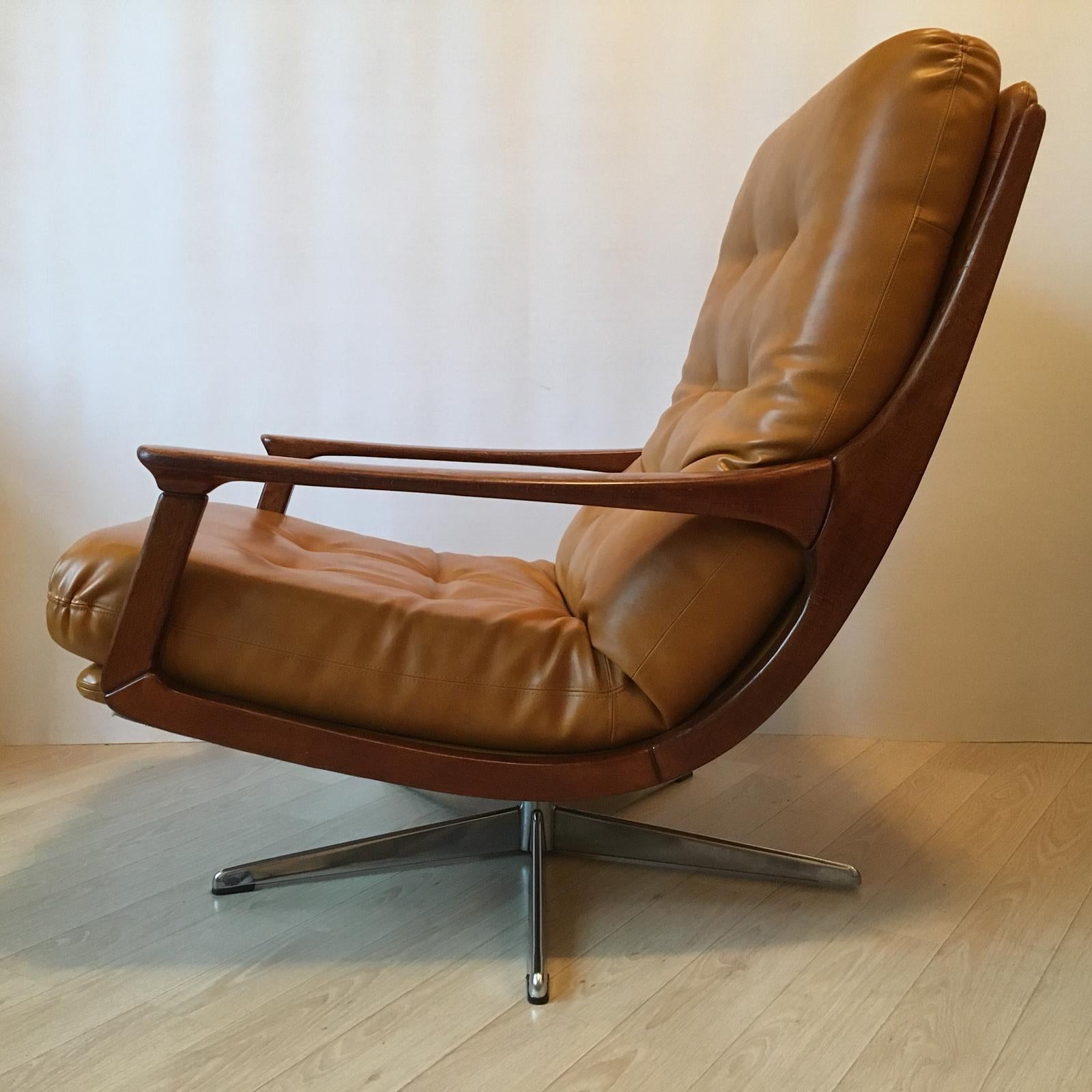 This vintage low armchair is very comfortable to seat, it is made of light brown leather and features wooden arms. It looks luxurious due to its color and soft lines of the wooden parts. I like combination of leather with warmth of the wood.
I