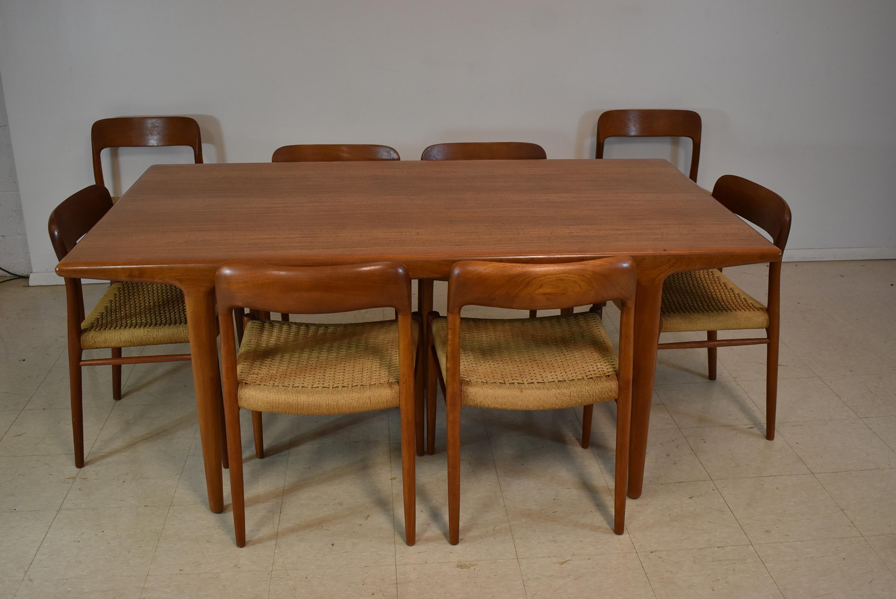 Mid-Century Modern Niels Moller teak tale with eight chairs. Rush seats. Table has two leaves and extends to 104