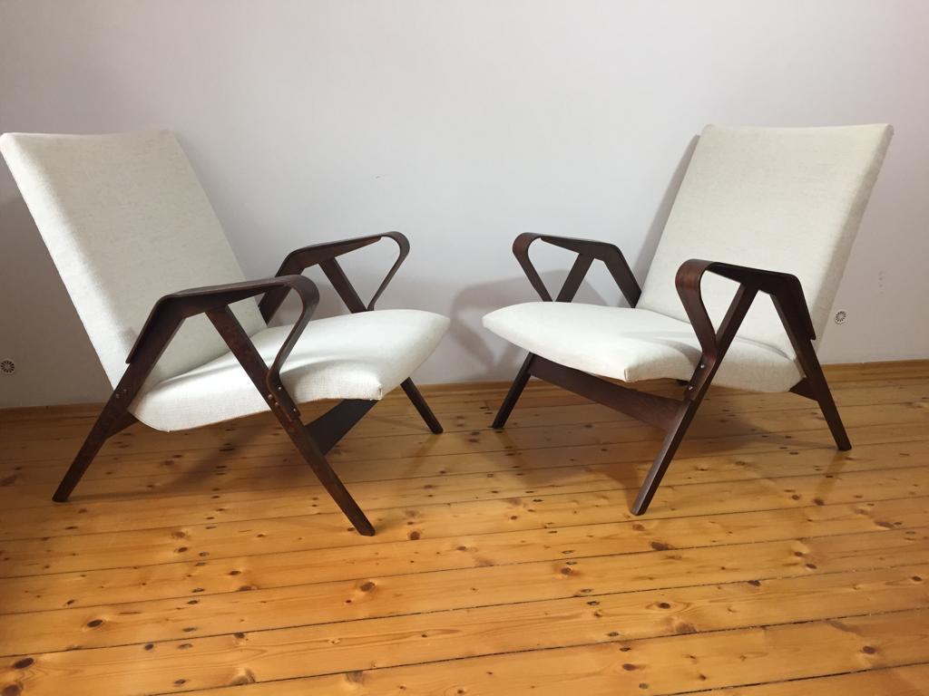 Beech frame with beech plywood armrsts, new upholstery with wool fabric. Made in the Czech Republic in the early 1960s.
Price is for a set of two armchairs and a stool as shown on the pictures.
