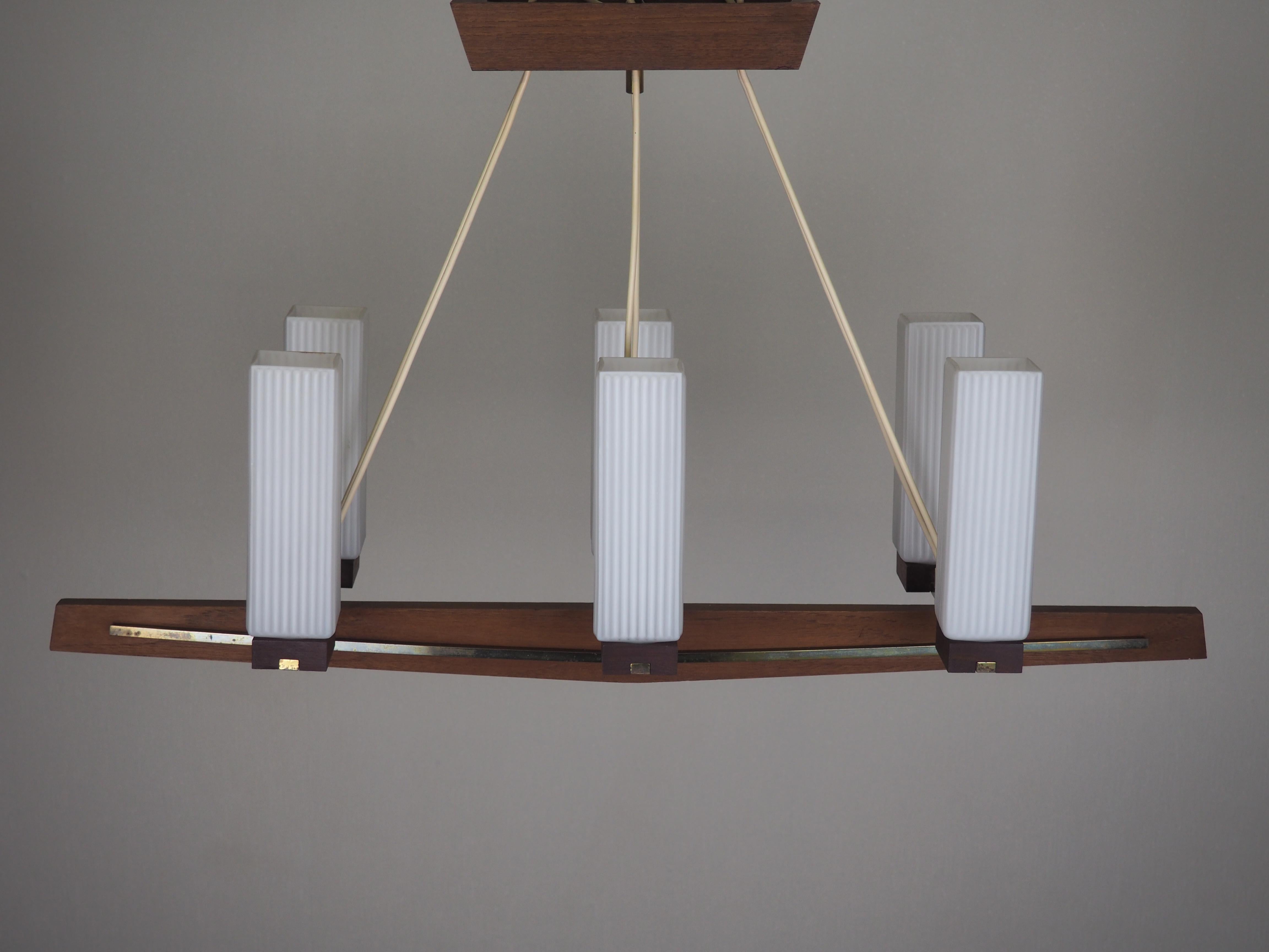 A beautiful, rectangular midcentury six-light teak, brass and opal glass chandelier, Denmark, circa 1960s.
Adjustable in the height.
Socket: 6 x e 14 - three e14 (Edison) for standard screw bulbs.
The condition is excellent.
 