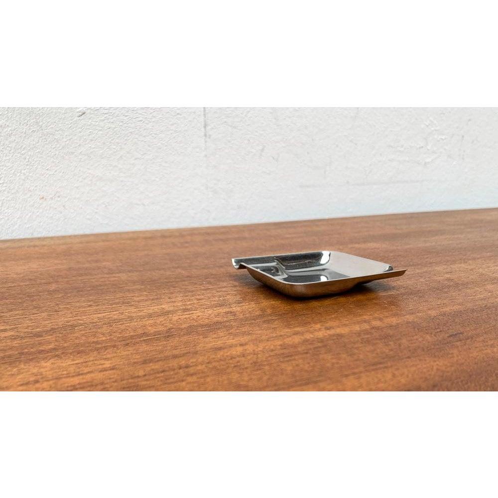 Mid-Cenutry Minimalist Ashtray from Wmf, 1960s, in Very Good conditions. Designed 1960 to 1969 This piece has an attribution mark.

Additional information:
Materials: Metal
Style: Mid-Century Modern, Minimalist
Country of Origin: Germany
Color:
