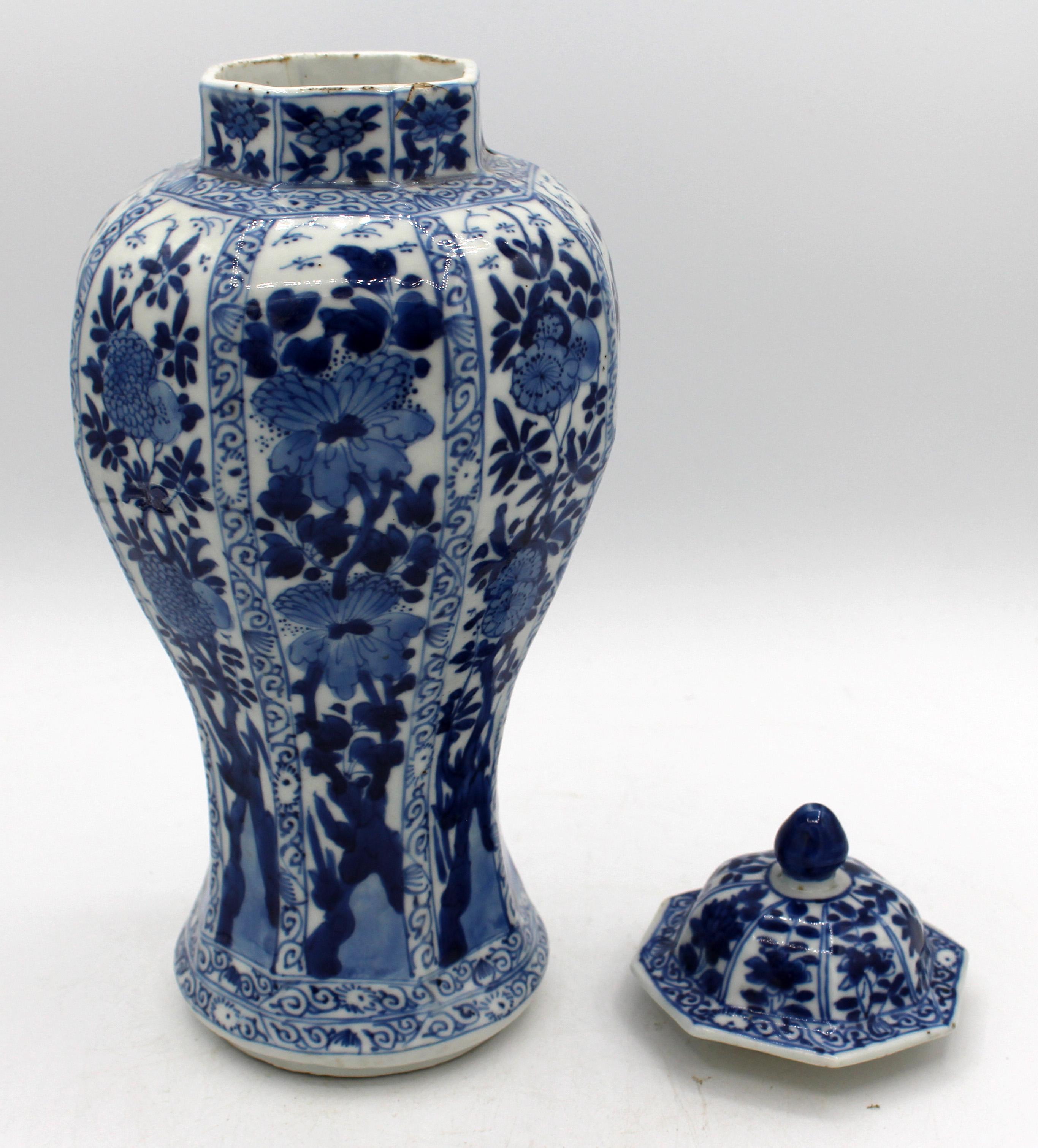 Mid-late 18th century pair of Chinese Export blue & white covered jars. Qianlong period. Temple jars or garniture jars. Octagonal forms enhanced by decoration of vining, twining flowers & branches flowing upward. One cover with rim frit & glaze
