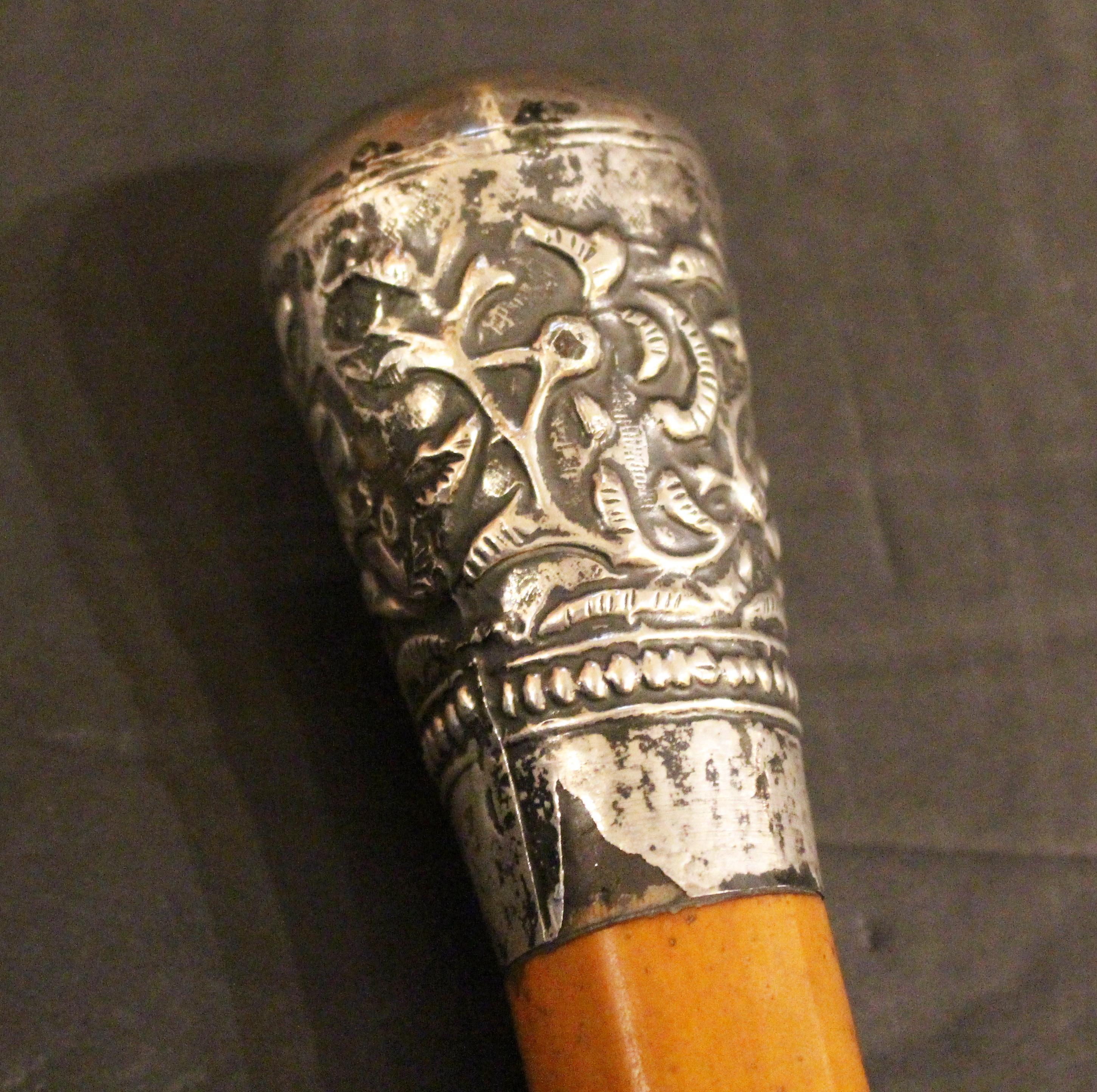Mid-late 19th century Anglo-Indian Raj Era Walking Stick. Malacca with sterling handle. Indecipherable Indian hallmarks on the silver. Brass tip - very worn with joint opened 0.5