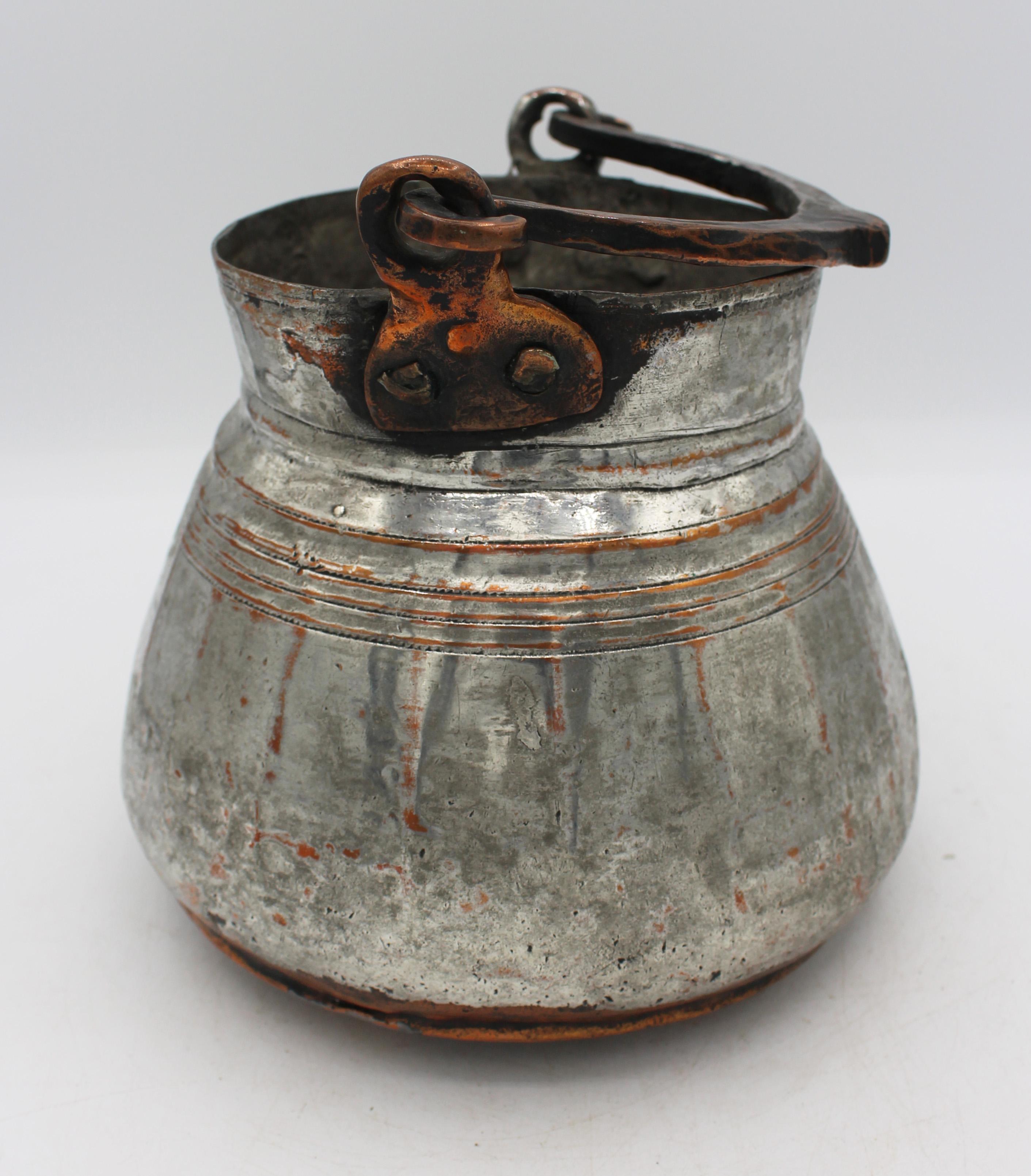 Mid-late 19th century tinned copper cooking or yogurt pot from Eastern Turkey. Of unusually good design with panelled sides & concentric incised decorative lines. Swing handle.
7.5