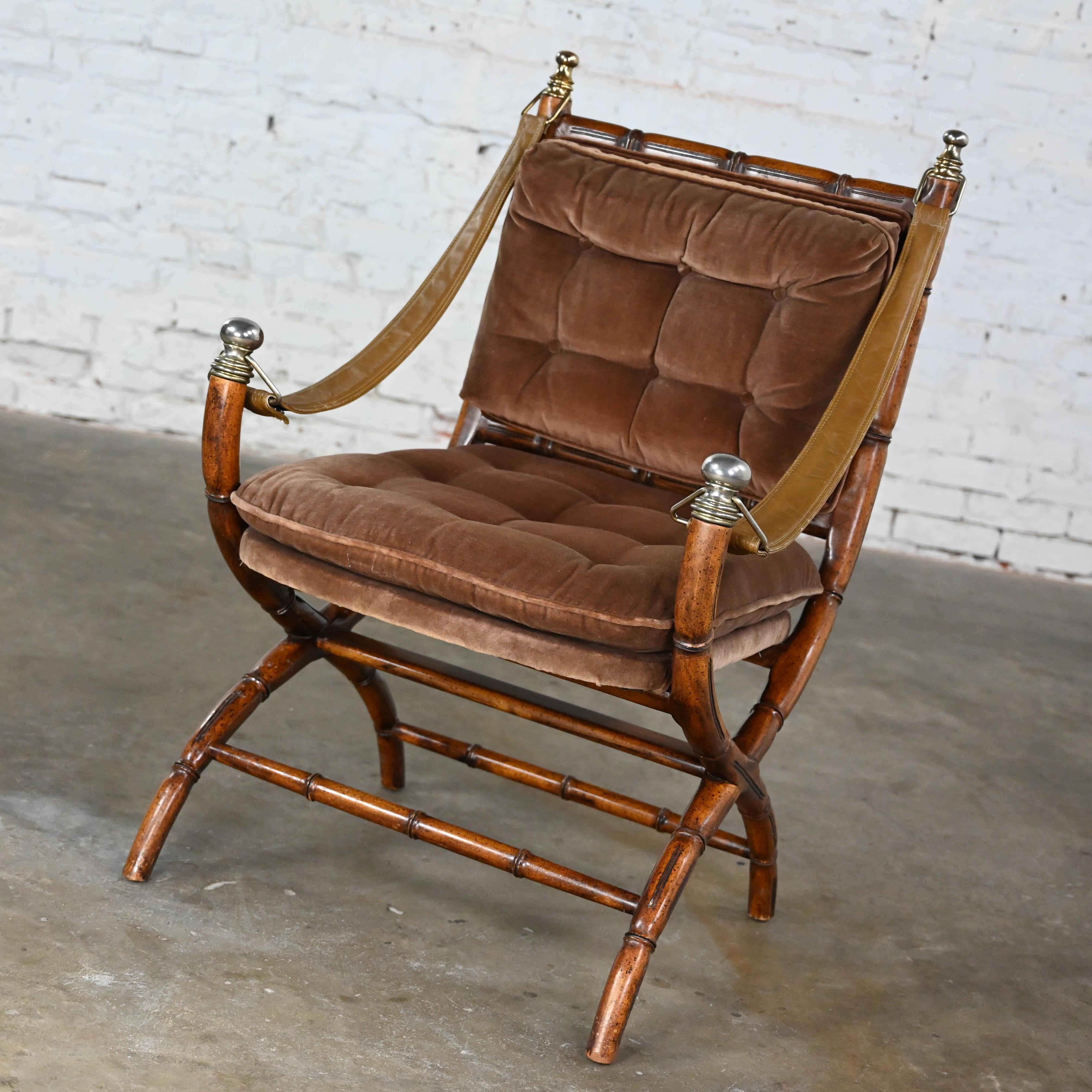 Wonderful vintage Campaign style chair with an X-shaped base, brown vinyl faux leather sling arm straps, faux bamboo wood frame, brown chenille velvet upholstery and distressed brass/chrome details. Beautiful condition, keeping in mind that this is