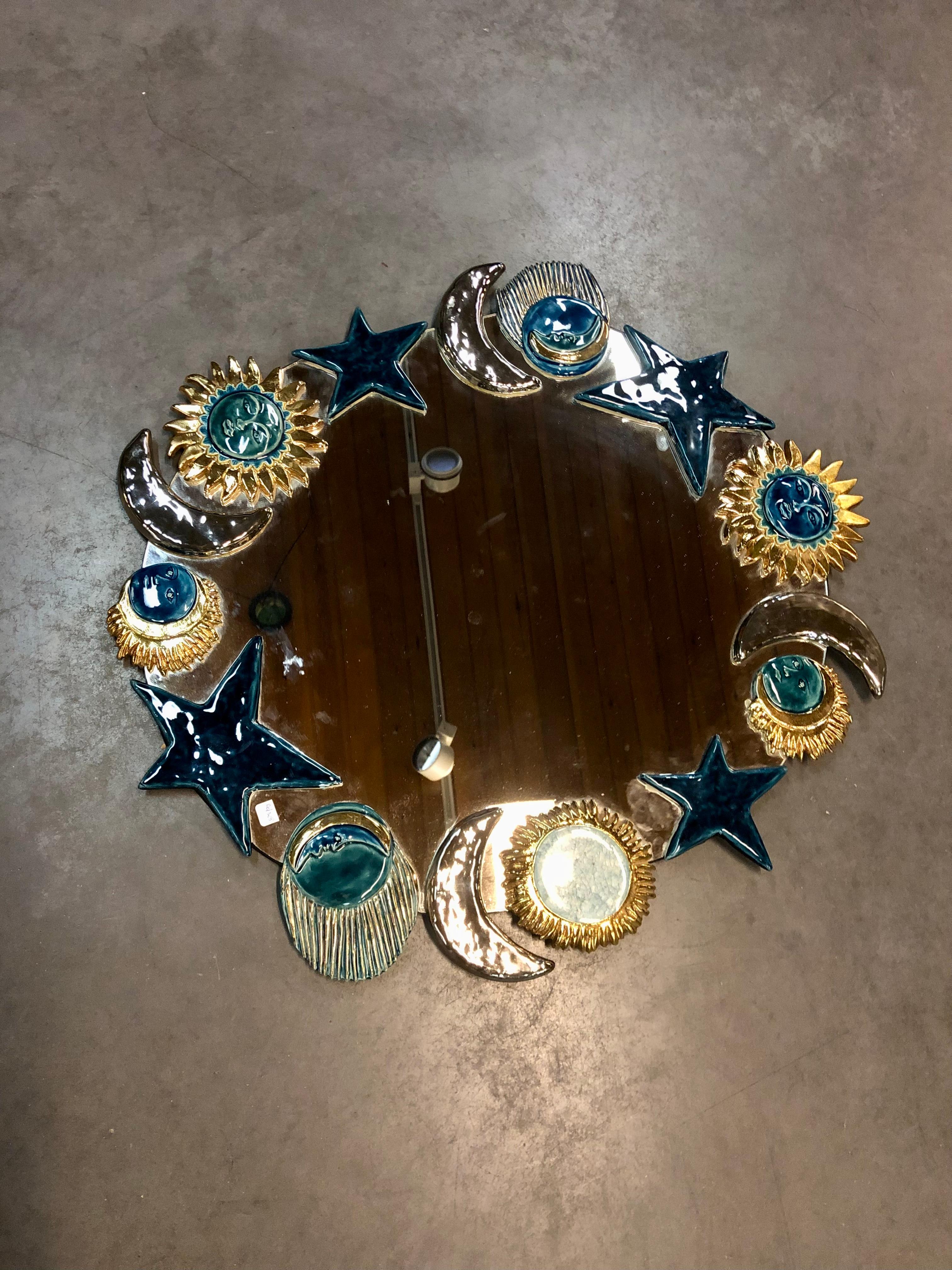 Important sunburst mirror from French atelier of  Mithe Espelt.
It’s made with enameled ceramic representing stylised moon sun and star.
Made and designed  by Marion de Crecy the daughter of Mithe Espelt .