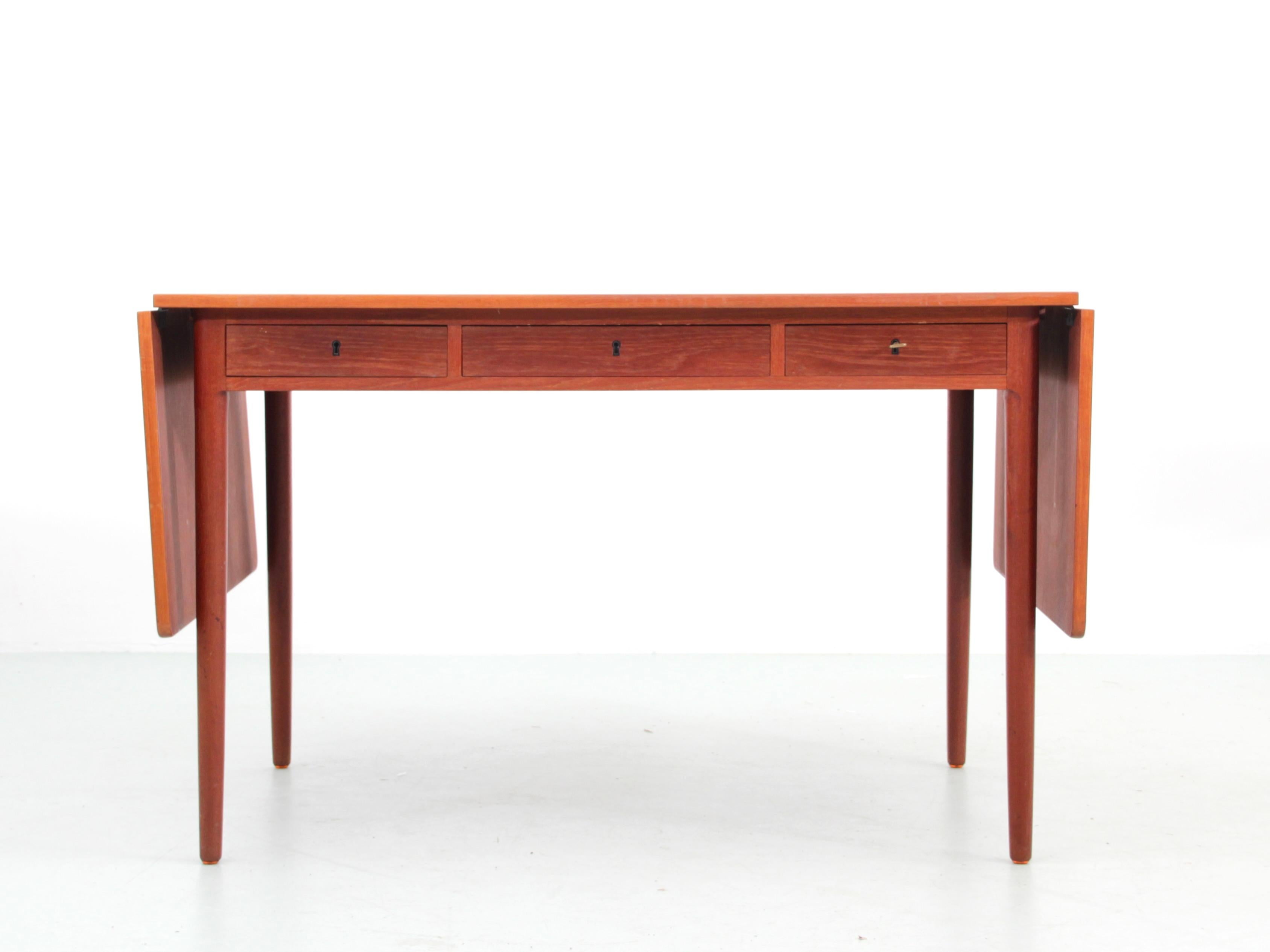 Mid modern danish standing desk in teak attriduted to Hans Wegner. 3 drawers in the apron and two flip-down leaves

