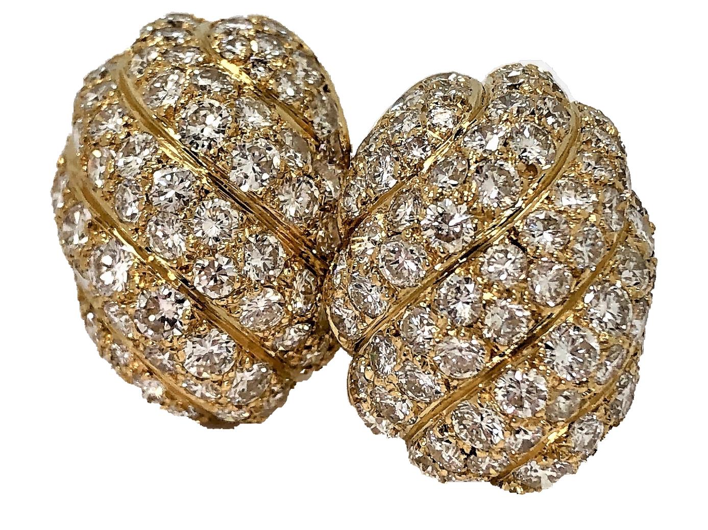 These lovely French, clip on dome earrings made of 18K yellow gold, are set with 
168 round brilliant cut diamonds in a graceful, swirl design. The diamonds weigh 
an approximate total of 6.25CT of overall F/G Color and VS1 Clarity. 
Ideal for the