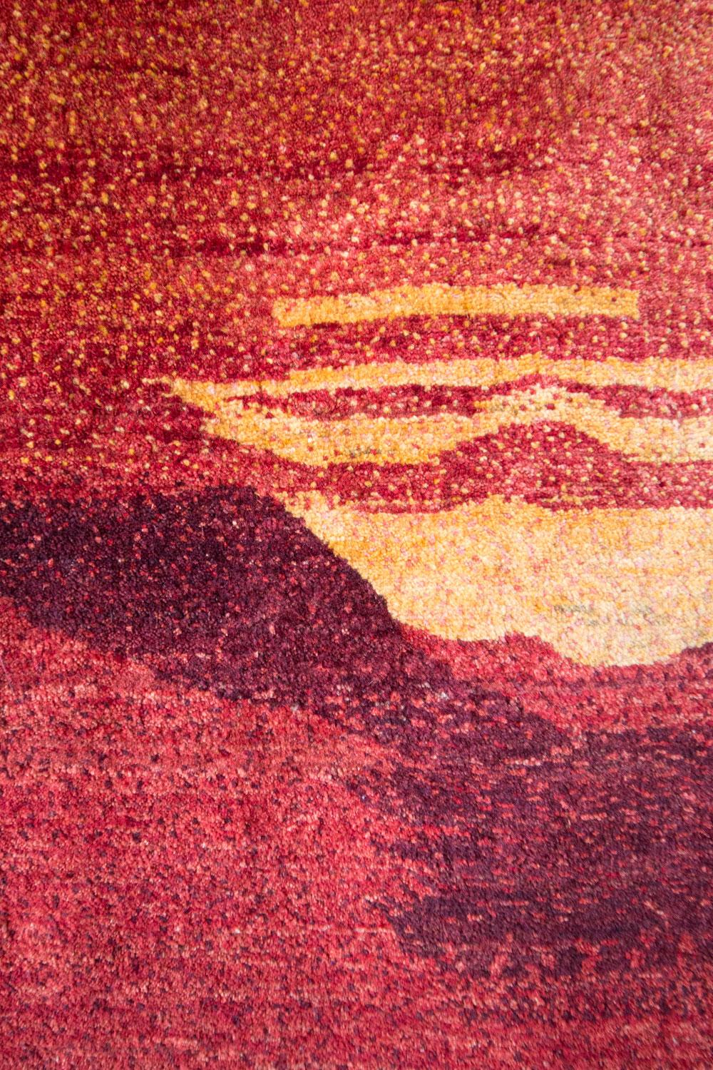 Mid-size red and orange contemporary tribal landscape Gabbeh Persian wool rug. Technically a landscape rug (featuring a Zagros mountain range lit by a fiery sunset) this Gabbeh works more like an abstract, contemporary painting. In addition to a