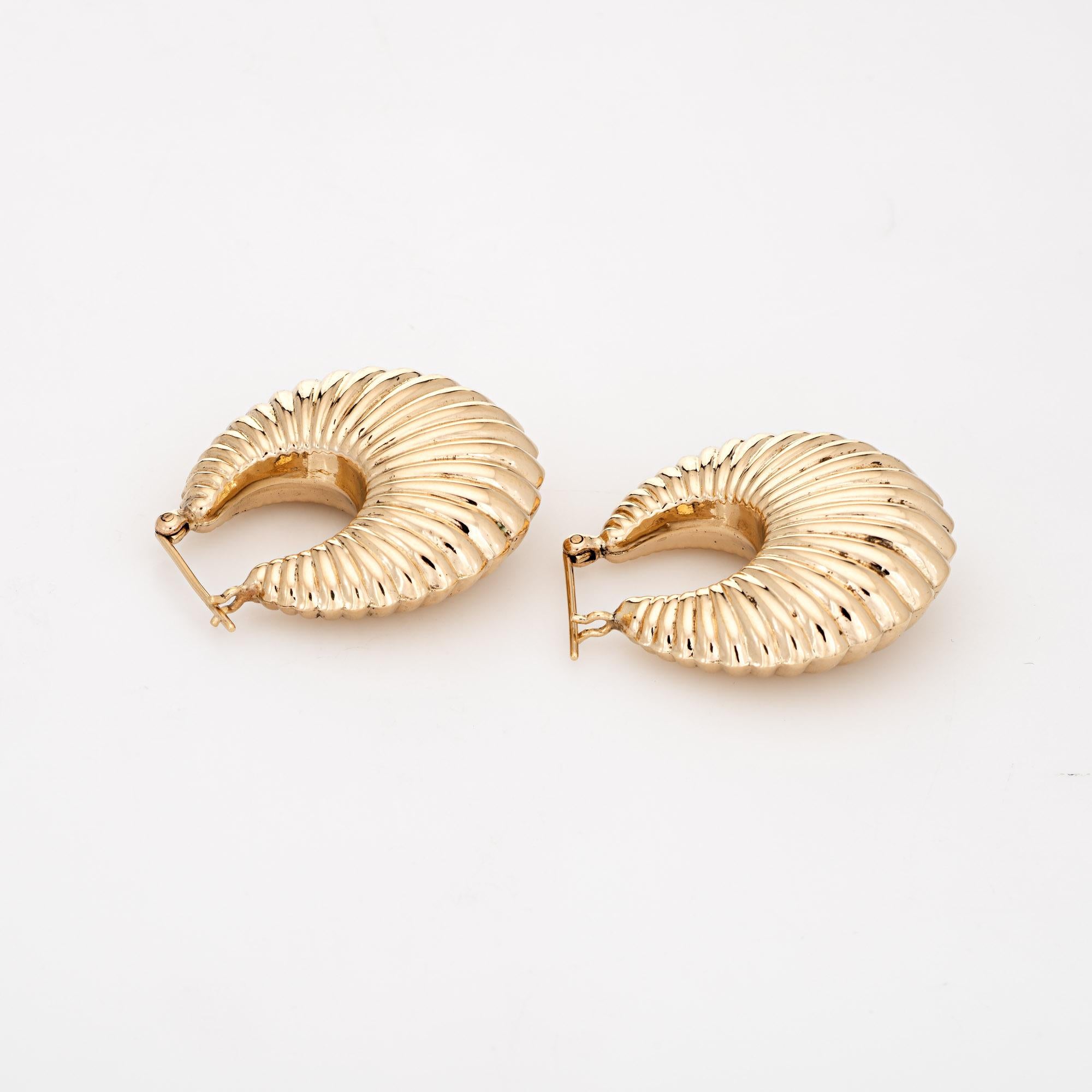 Elegant pair of vintage hoop earrings (circa 1980s to 1990s) crafted in 14k yellow gold. 

The charming earrings are crafted in a puffed shell design. The earrings are hollow and sit comfortably on the earlobe. Ideal for day or evening wear. The