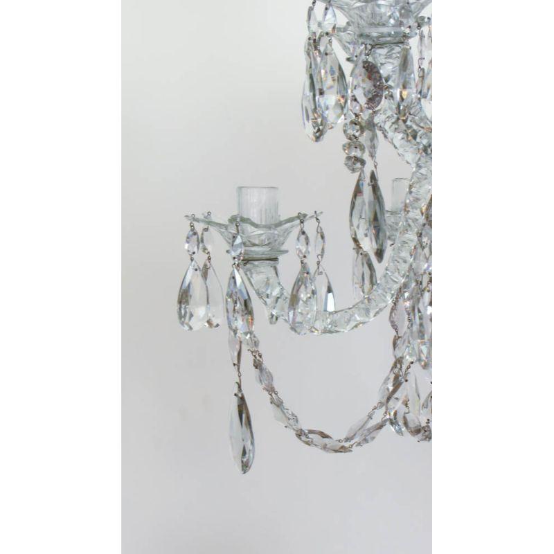 Mid to late 18th century English cut glass chandelier. 12 light. Blueish Grey Tinted Crystal, referred to as “Derby Blue” Crystal, from ores mined prior to 1810 in Derbyshire England. Almond Cut Crystals, Large Candle and arms characteristic of