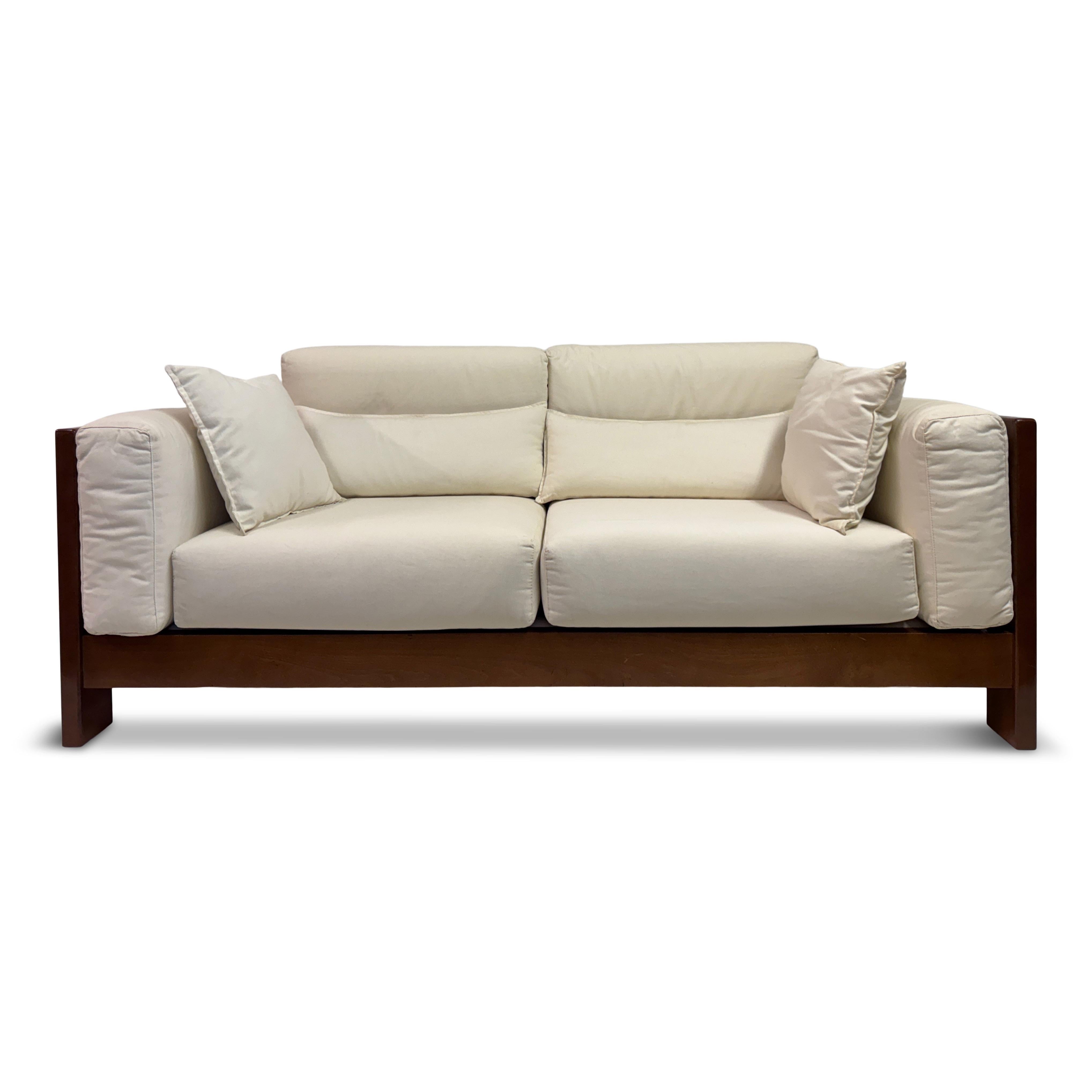Mid to Late 20th Century Italian Sofa

A generous Italian sofa from the 1970s or 1980s, designed with a strong architectural frame in solid wood and deep, inviting cushions. The contrast between the dark timber and the crisp white upholstery is both