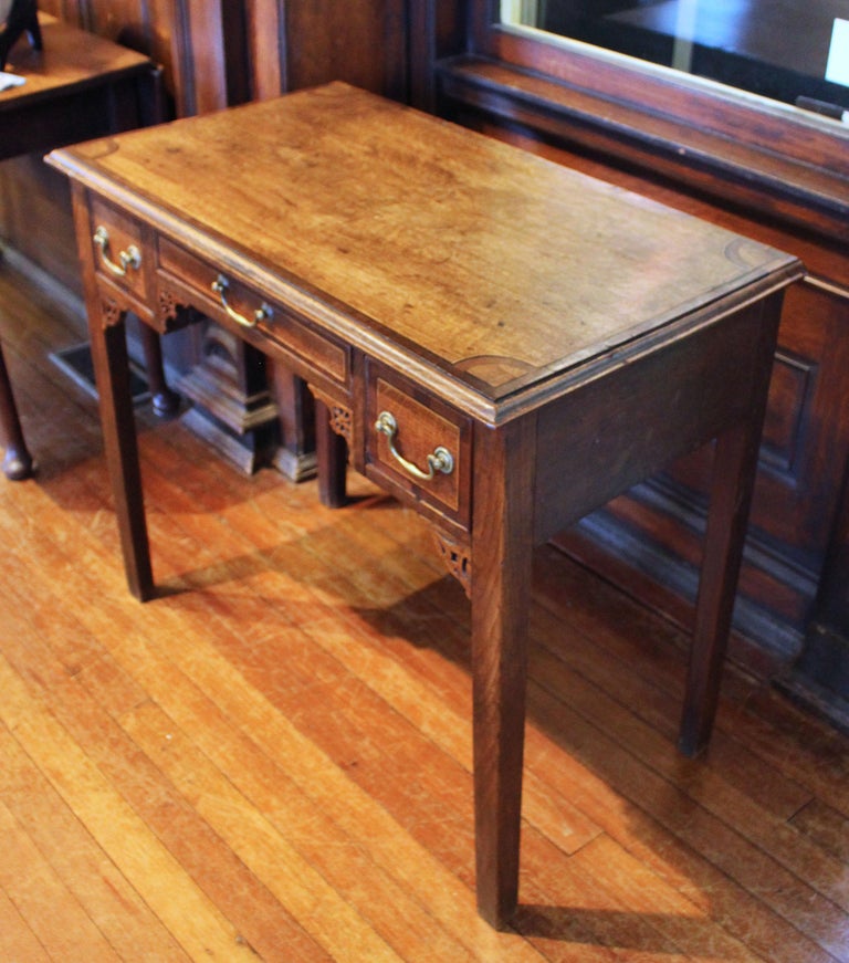 Mid-late 18th century lowboy table with three drawers of oak with inlays. George III, English, provincial or midlands/north country. The top with cross banded and with ovolo shaped corners of mahogany with ebony and contrasting boxwood stringing