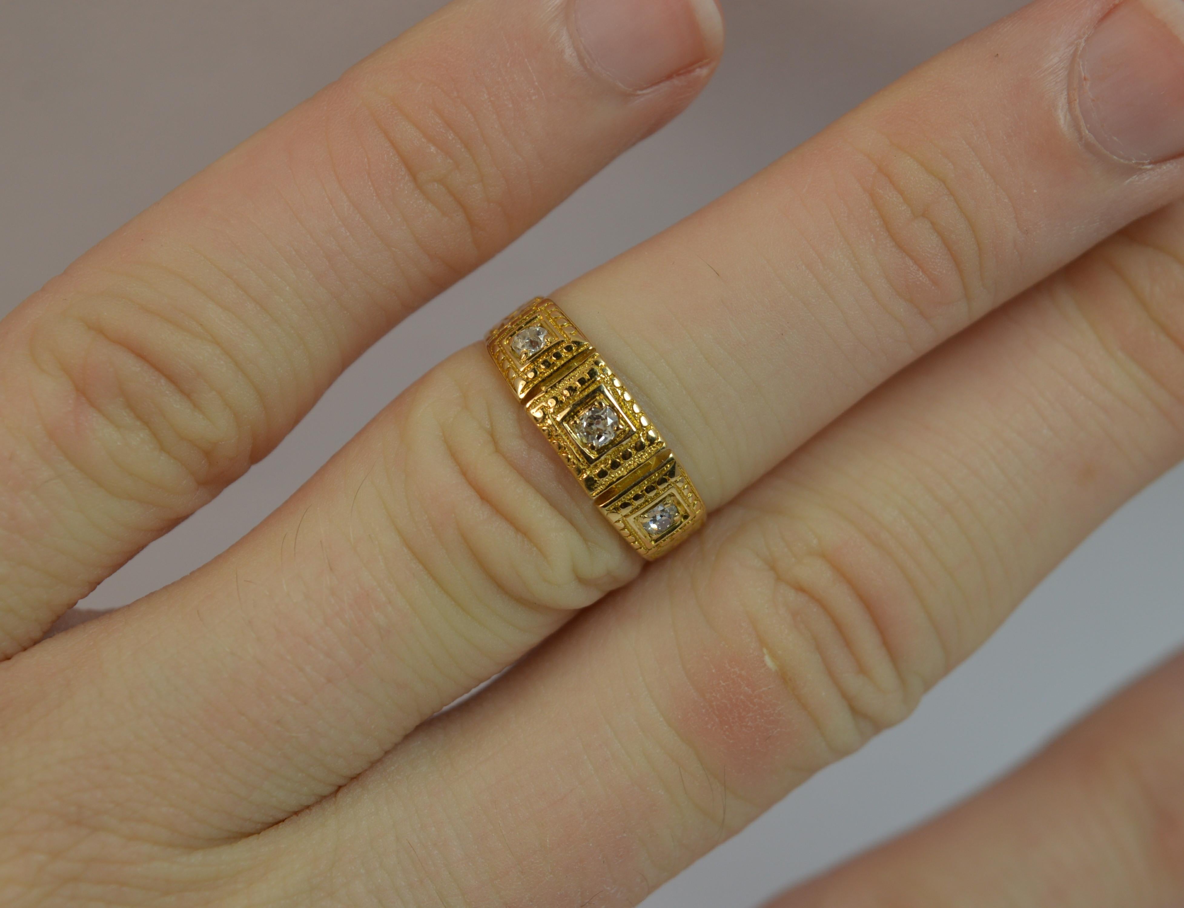 
A LADIES DIAMOND, 18ct GOLD DIAMOND RING, c1870.

SOLID YELLOW GOLD BAND WITH FULL HAND ENGRAVED PATTERN RUNNING THROUGHOUT THE BAND.

15MM X 5.5MM HEAD OF THE THREE  DIAMONDS.

THREE OLD EUROPEAN CUT DIAMONDS.

SIZE K 1/2 UK, 5 1/4 US. 2.7