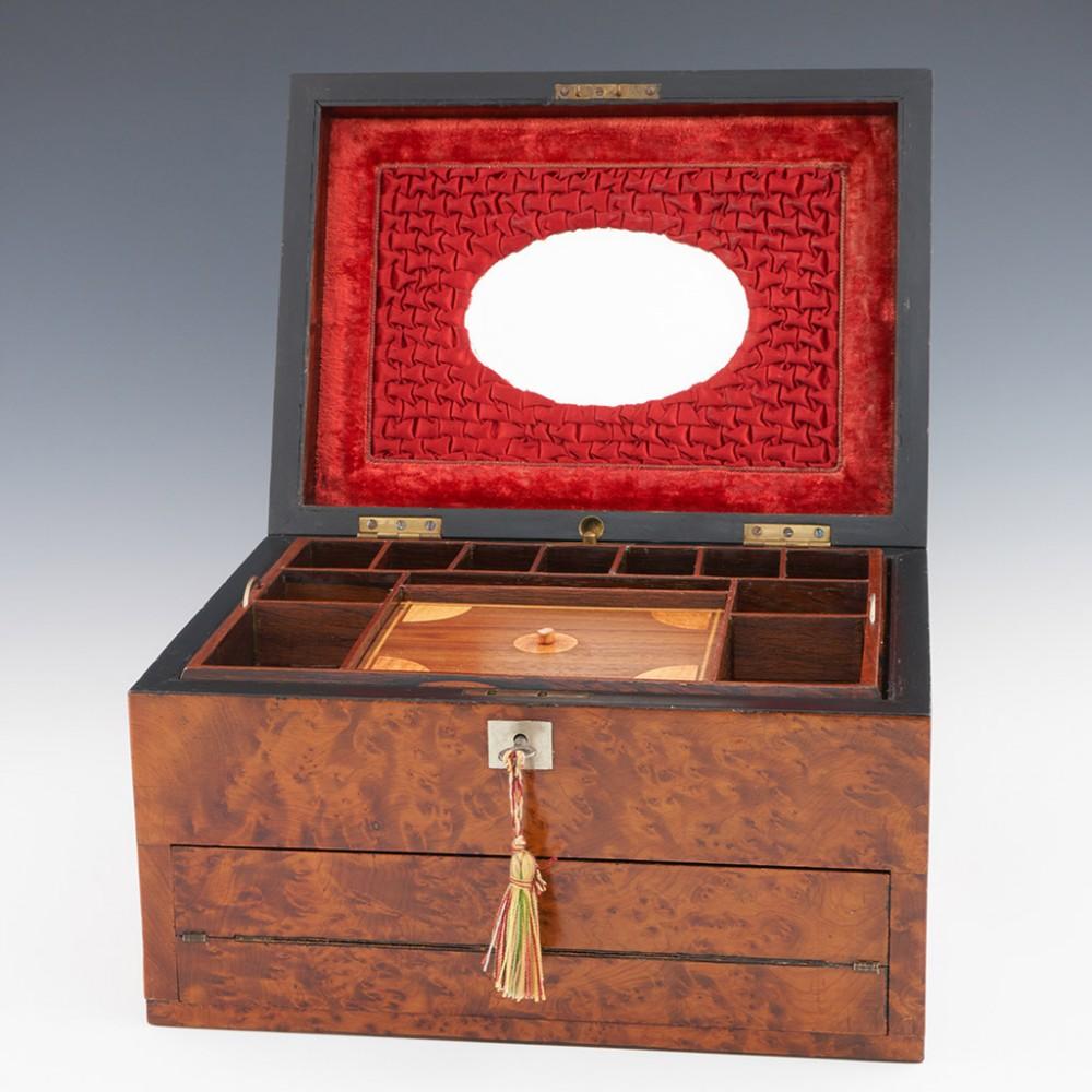 Heading : Amboyana jewellery box and writing slope
Date : c1860
Period : Victoria
Origin : England
Decoration : Bird eye maple box with amboyana edging inset with abalone and shell designs and vacant brass cartouche. The interior with plush vlevet