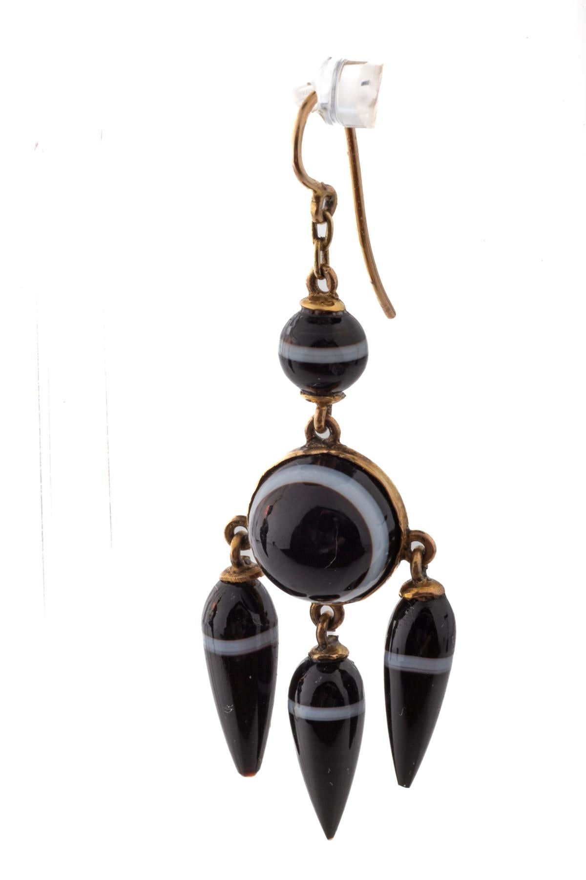 It is unusual to find Mid Victorian Banded agate earrings in girandole form. These earrings have perfectly matched white bands at the center of the teardrops and at the top of the earrings. They have the romantic quality to move with he slightest