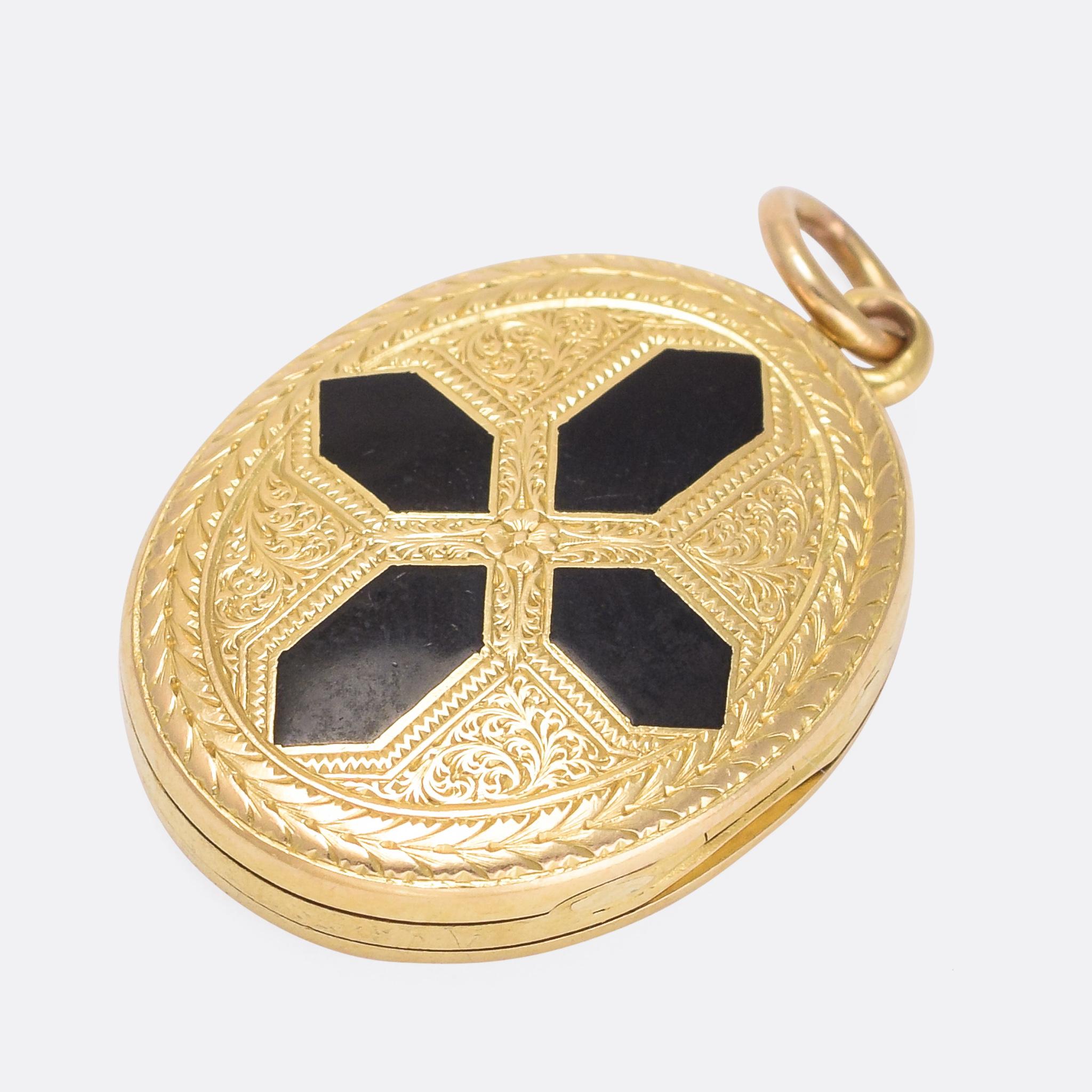 A cool antique double locket dating from 1859. It's hinged on both sides, meaning that both the front and back can open independently of one another - quite an unusual feature. The front is intricately hand-chased with a black enamel cross motif,
