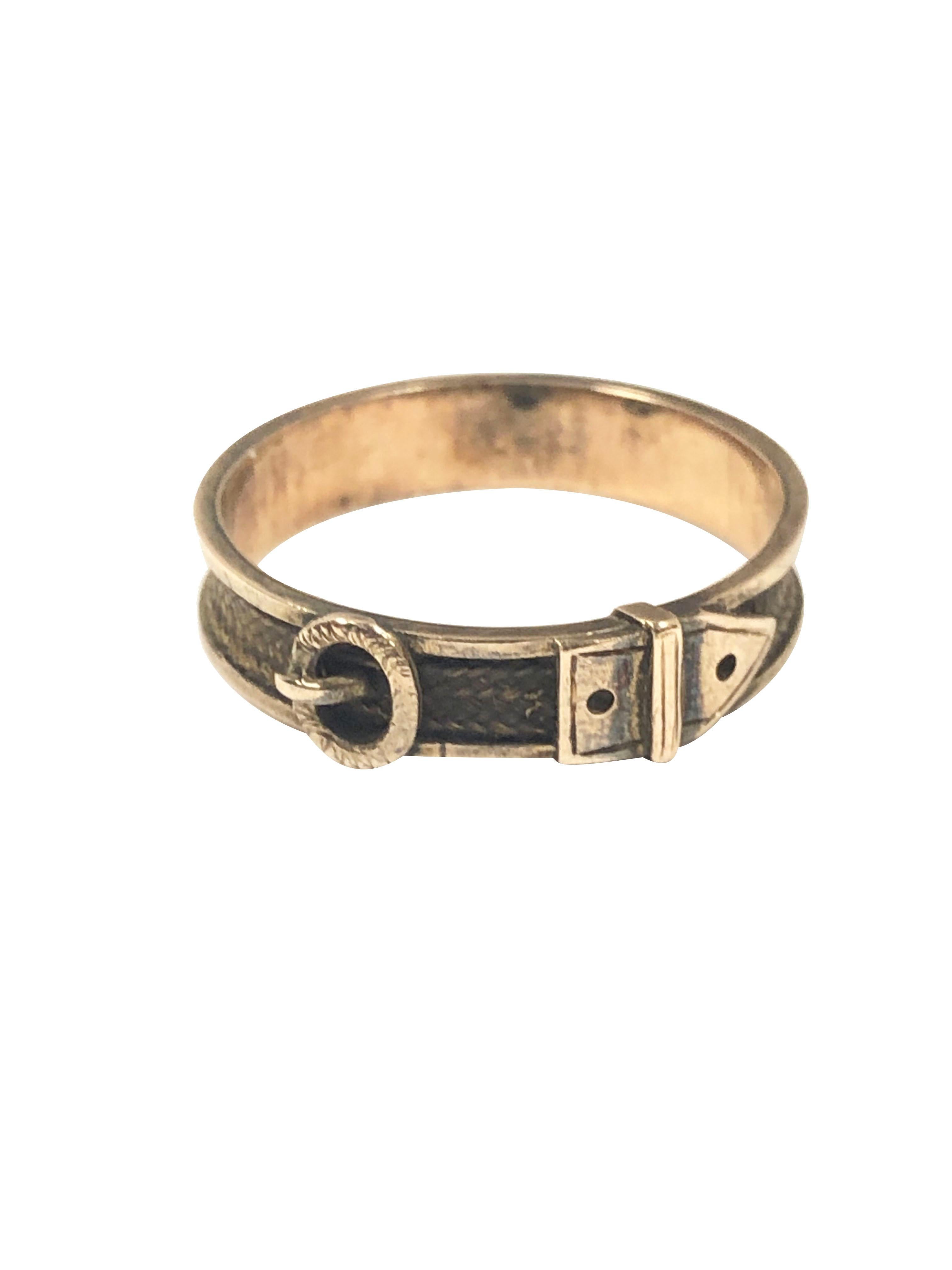 Circa 1850s Yellow Gold Buckle Form Mourning, Memorial Ring, measuring 3/16 inch wide with the center set with woven hair.  Finger size 10,  amazing, excellent condition considering the age.