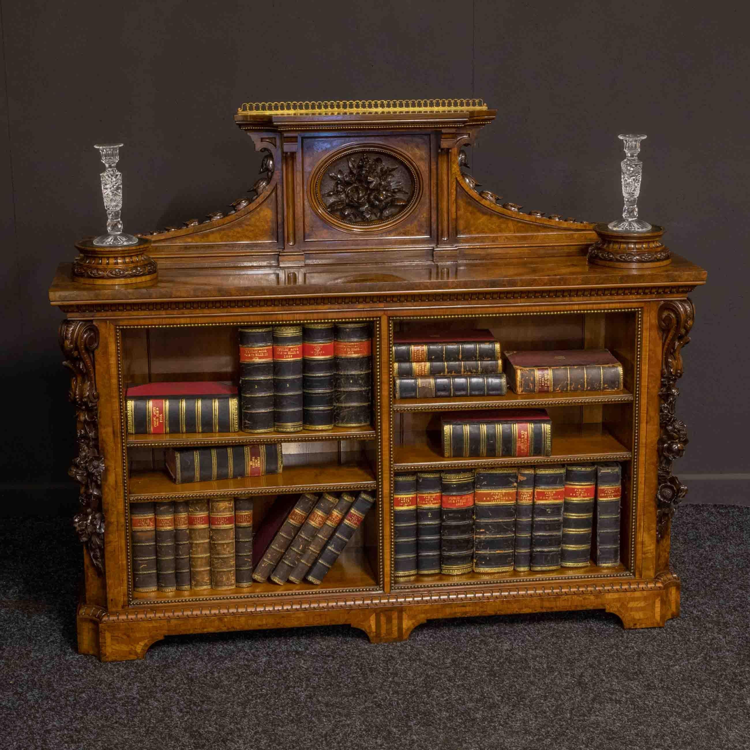 A most unusual Victorian burr walnut veneered bookcase of quite low standing yet absolutely original. Rare to get a pair of plinths set into the top still with their tooled leather surfaces. These would look fantastic with a pair of Parian figures