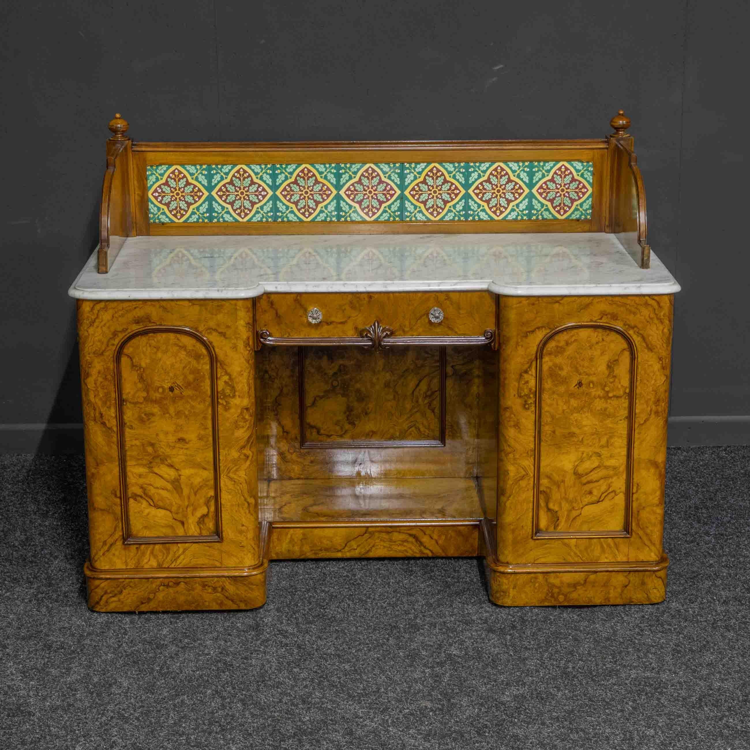 A stunning burr walnut veneered washstand from the Mid Victorian period. The tiles are most likely by Minton and have Aesthetic movement overtones within their design. Of exceptional quality as can be discovered when opening the cupboard doors,