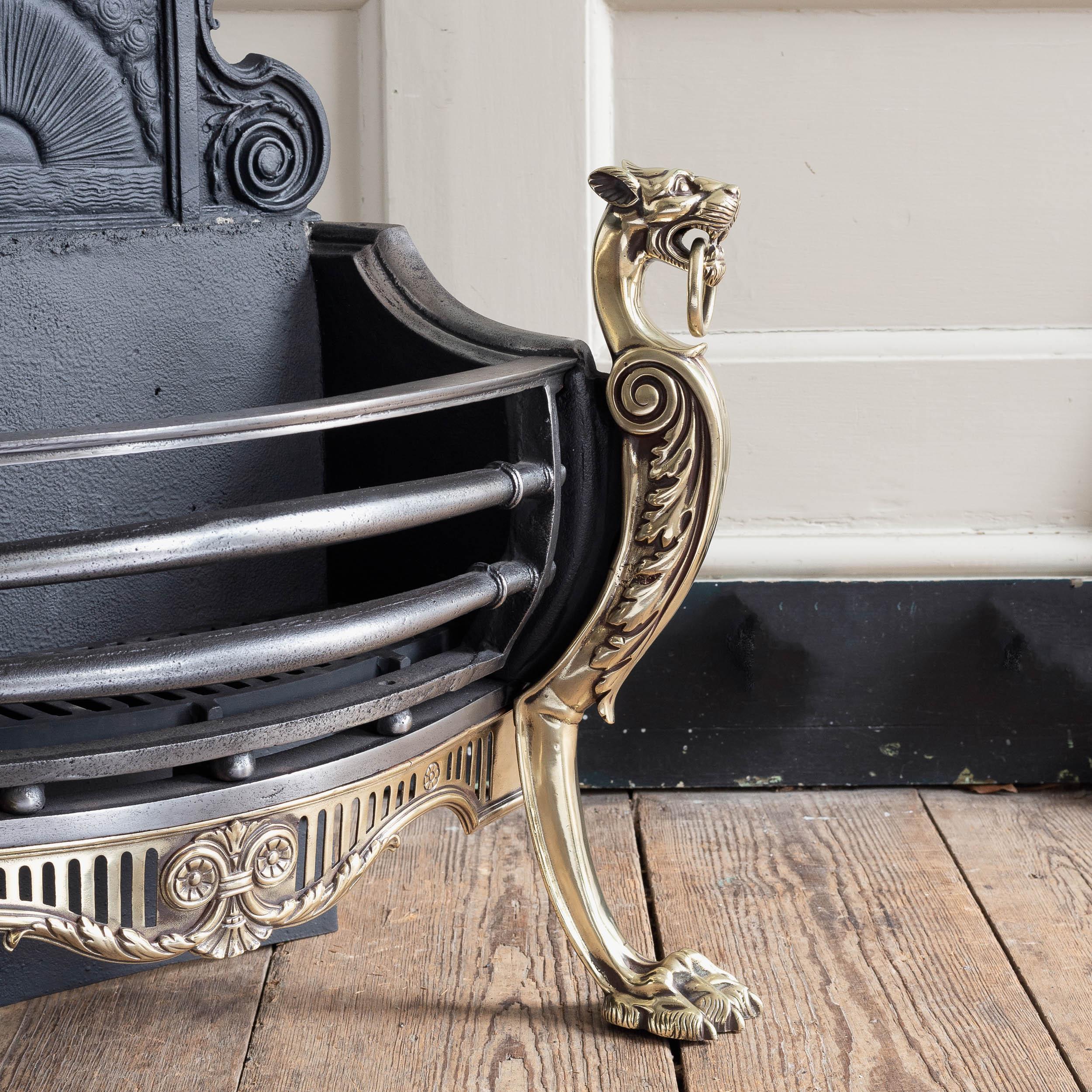 Mid-Victorian cast iron and brass fire grate with decorative backplate and Panther monopodia standards flanking the railed basket.

Restored, re-polished and ready to use immediately.