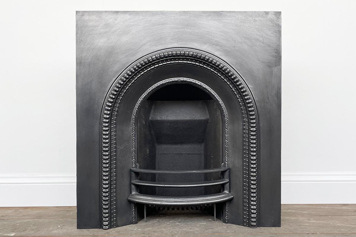 A restored mid-Victorian cast iron arched fireplace insert. Circa 1870.

Finished with traditional black grate polish and supplied with a new clay fireback and cast iron bottom grate, ready for a solid fuel fire. We can also supply a living flame