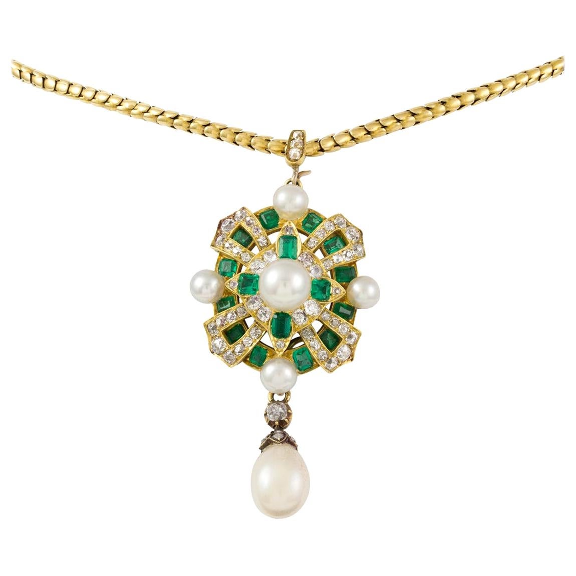 A magnificent mid-Victorian natural peal, emerald and diamond pendant, to the centre a natural pearl measuring approximately 7.7mm in diameter, surrounded by a lozenge-shaped frame set with four rectangular-cut emerald and eight old European-cut