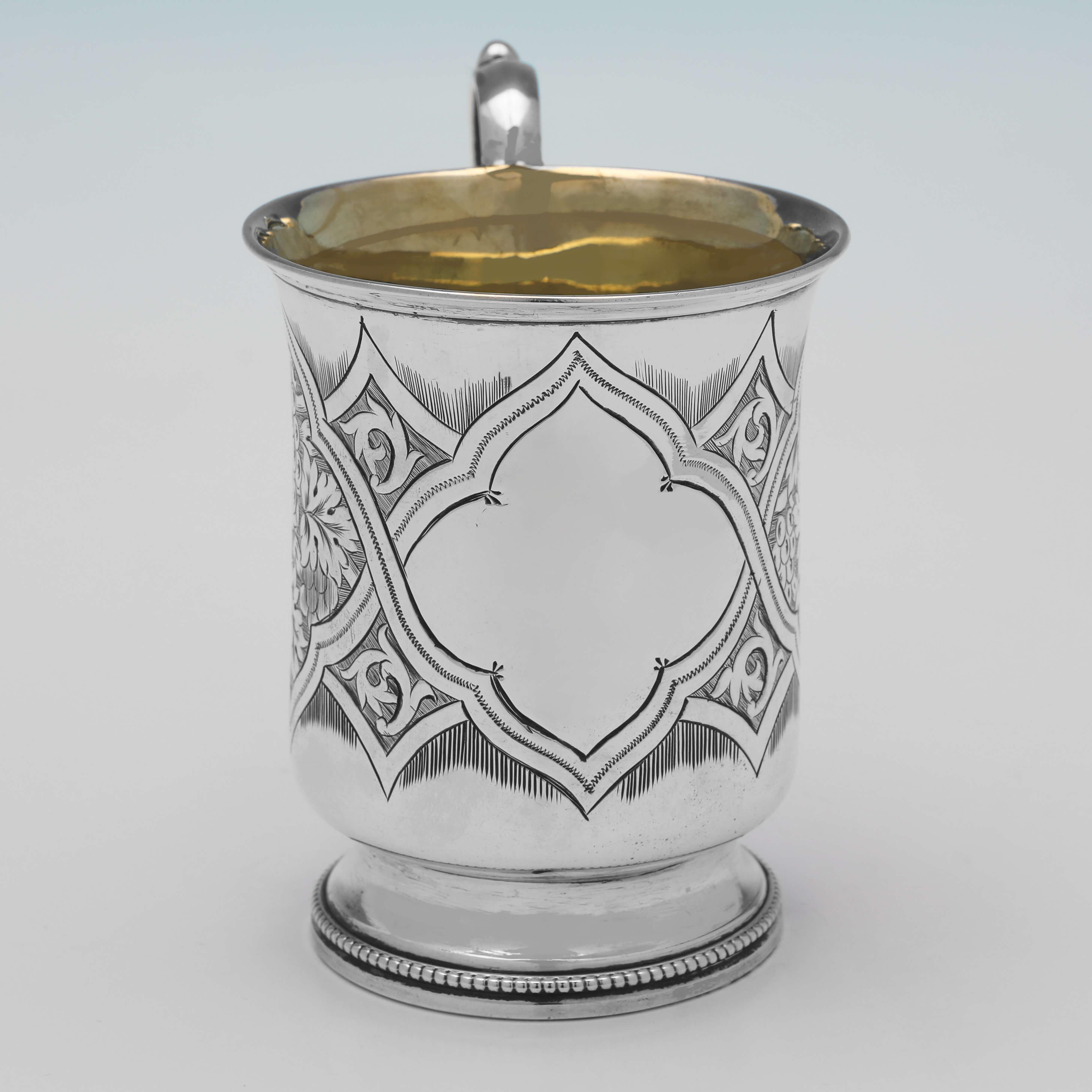 Hallmarked in Birmingham in 1863 by Hilliard & Thomason, this striking, Victorian, Antique Sterling Silver Christening Mug, features wonderful engraved decoration to the body, bead borders, and a gilt interior. 

The christening mug measures