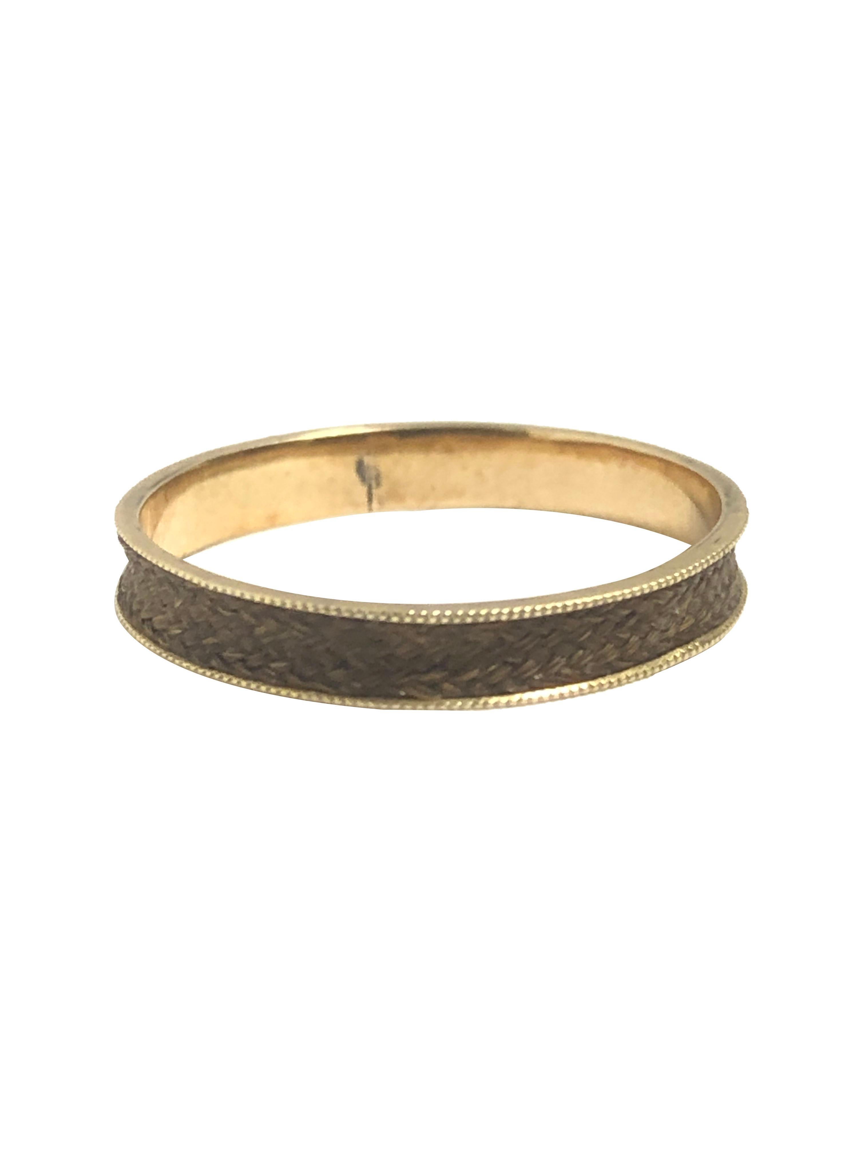 Circa 1850s Yellow Gold Mourning, Memorial Band Ring, measuring 1/4 inch wide with  delicate Milgrain edges, the center is very finely Woven Hair, a center Gold section has the Initials E.W. Finger size 8 1/2 
