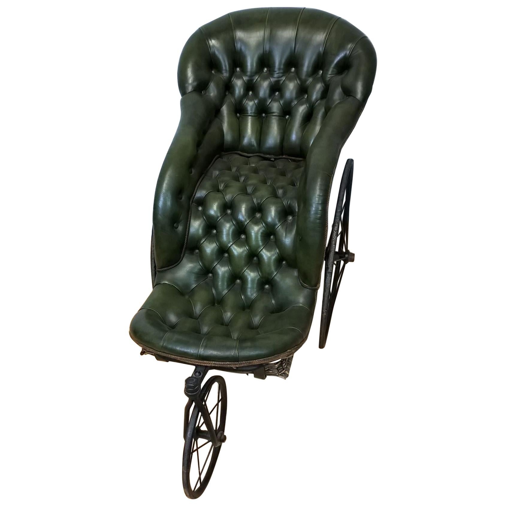 A Victorian iron framed bath chair with wickerwork back and sides and green leatherette buttoned upholstery.
The turned beach wood pushing handle uniting with the iron frame.
The whole in very good working order.
   