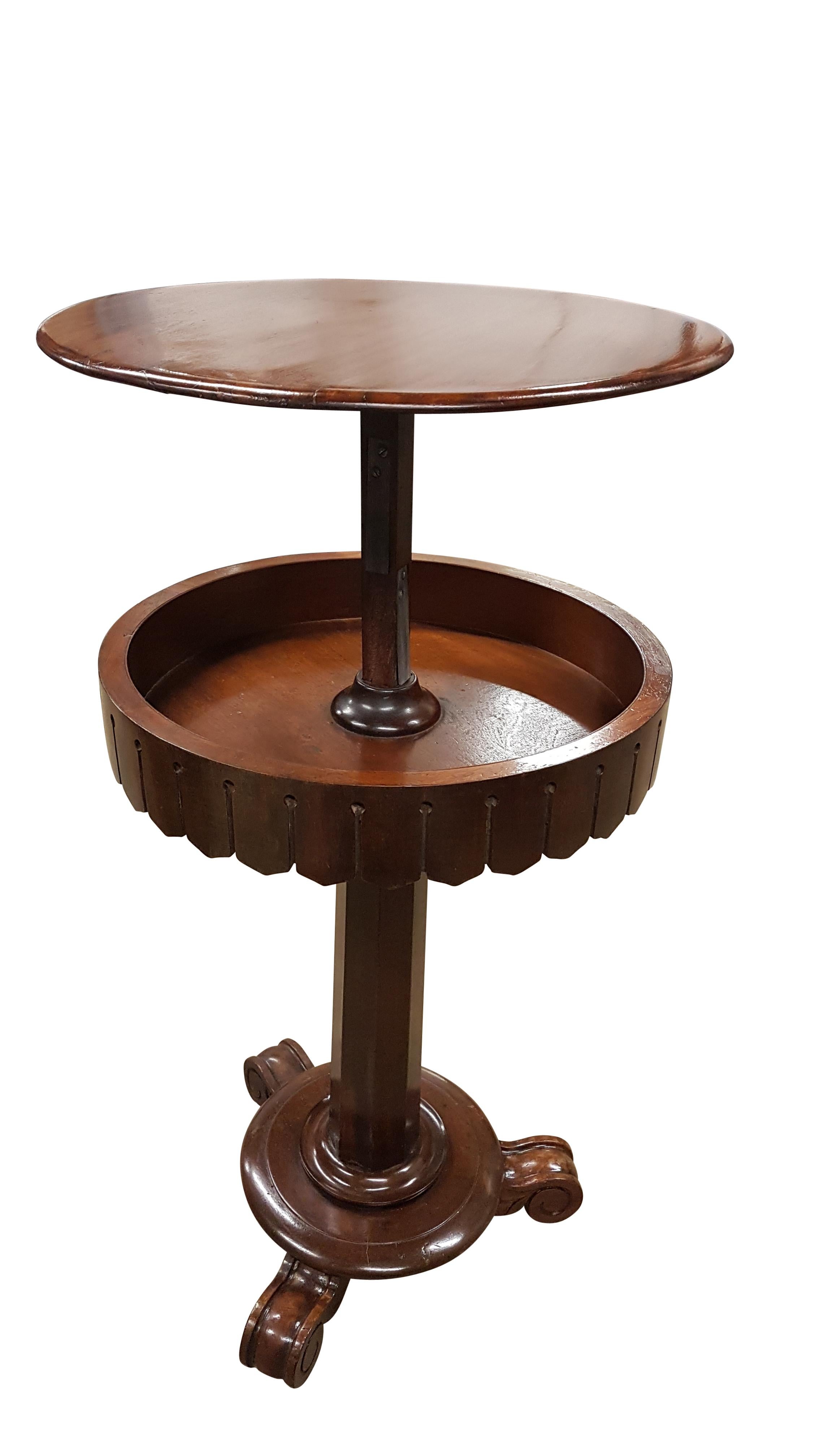 A charming quirky mid Victorian occasional table that has a rise and fall mechanism, although primitive it is effective. The table is in mahogany with shaped skirt, octagonal column with turned base and finished in carved mahogany feet with original