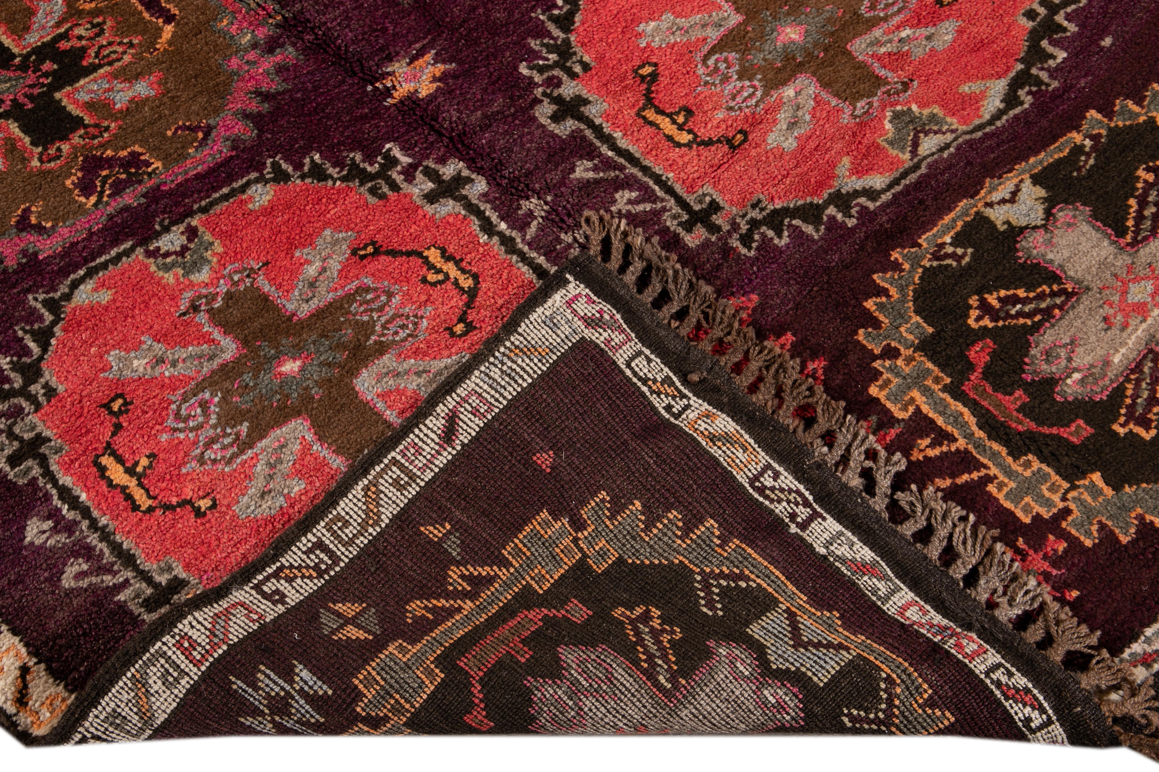 Beautiful vintage Turkish hand-knotted wool rug with a Purple field. This Turkish rug has an Ivory frame and multi-color accents in a gorgeous all-over geometric Tribal design.

This rug measures: 4'10