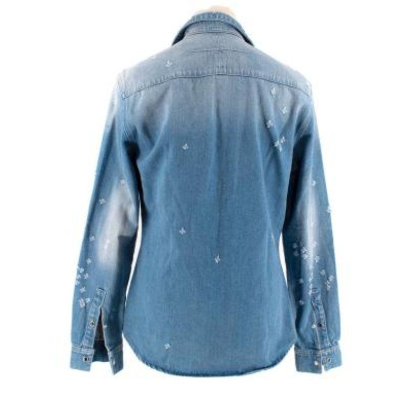 Givenchy Mid-Wash Distressed Denim Shirt
 

 - Allover distressing in the form of small cross shapes
 - Faded patches 
 - Point collar, long sleeve, snap fastening 
 - 2 patch breast pockets
 

 Materials: 
 100% Cotton 
 

 Made in Tunisia 
 

 Dry