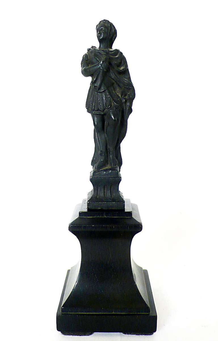 Italian Grand Tour pair of little white metal (bronze finishing patina) sculptures, depicting a figurine of a roman legislator and a roman warrior, mounted on ebony wooden base.