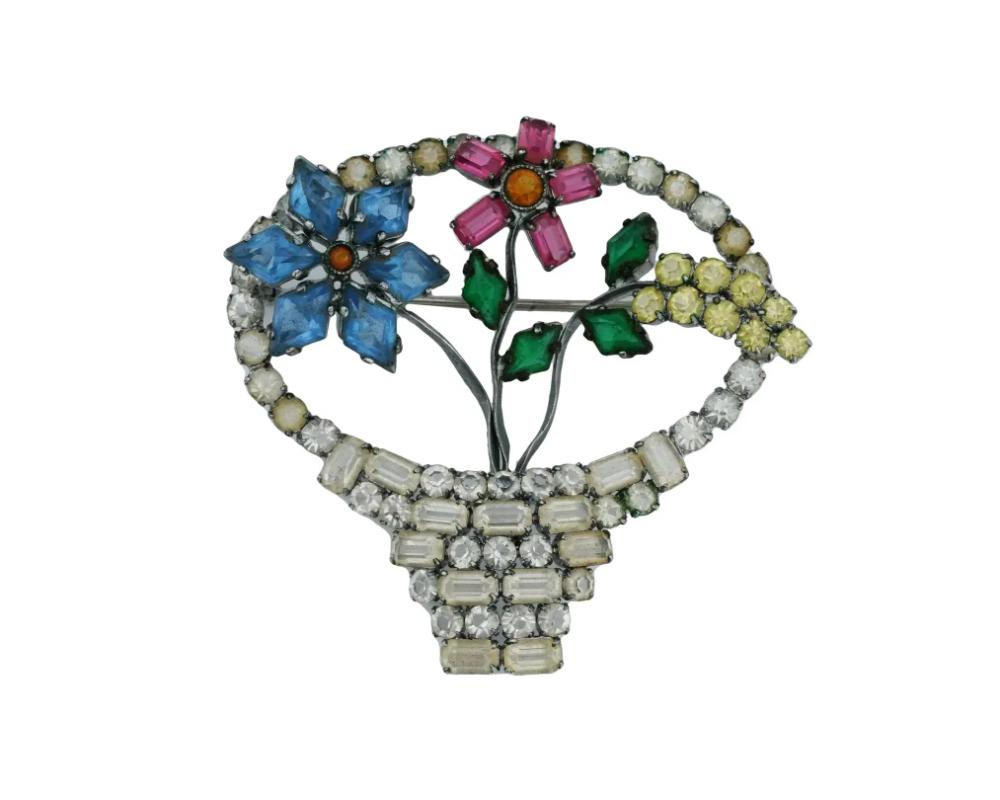 A vintage silver-tone metal pin brooch of floral design. Ca. 1970s. The piece is set with color glass and rhinestones. Marked Czechoslovakia on the backside. Collectible Costume Jewelry For Women.

Dimensions: H 2 in. All measurements are