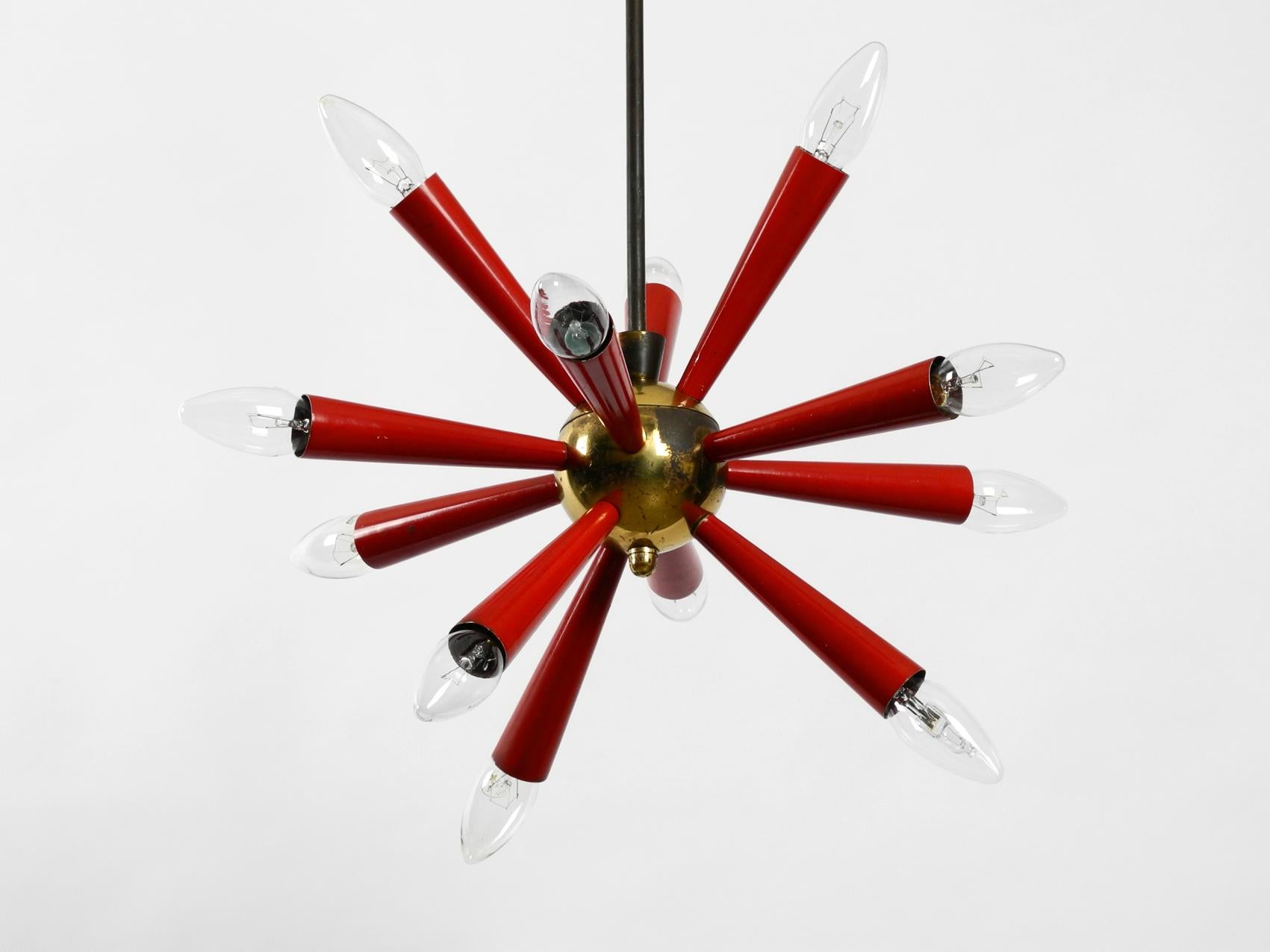 Very rare real Mid-Century Modernist Sputnik ceiling lamp, made of brass and red painted metal. Very nice classic of the 1950s and a atomic design classic in gorgeous condition with great patina. Twelve E14 sockets. Rod is made of brass, metal cones