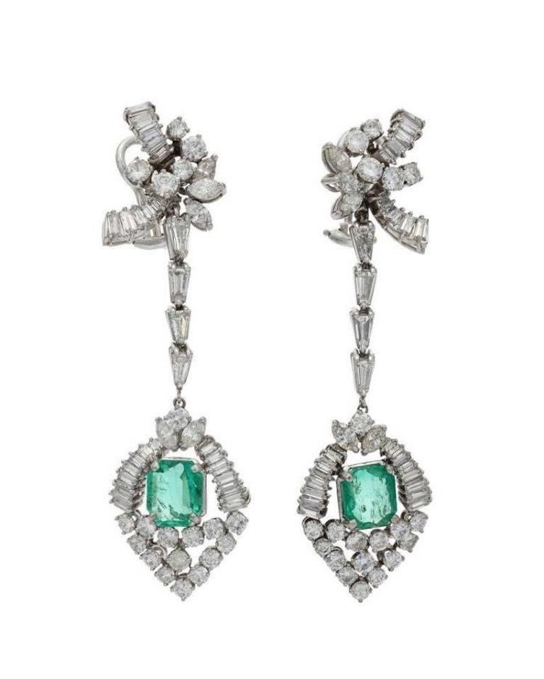 Stunning 1950s Mid-Century 14 karat gold estate pair of 9.70 carat total weight VS diamond and emerald earrings.

Impressive estate pair of high end important diamond and emerald ear pendant earrings, circa 1950, 14K white gold (tested).

These