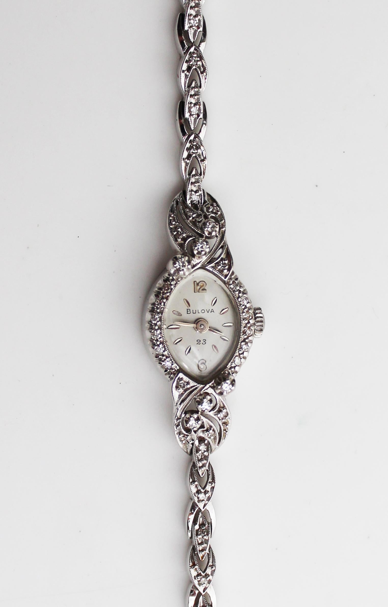 This is a gorgeous mid-century Bulova watch in 14k white gold set with diamonds and featuring a rope strap. The case is an elegant oval shape with a diamond frame featuring ‘shoulders’ that are set with lovely diamonds! The strap is a flexible