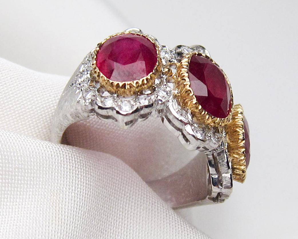 Circa 1960. This fabulous Buccellati ring features three mixed-cut natural rubies weighing 6.06 carats total, set in 18KT yellow gold bezels. Accenting the deep red rubies are 26 round brilliant-cut diamonds weighing .48 carats total with an SI1-SI2