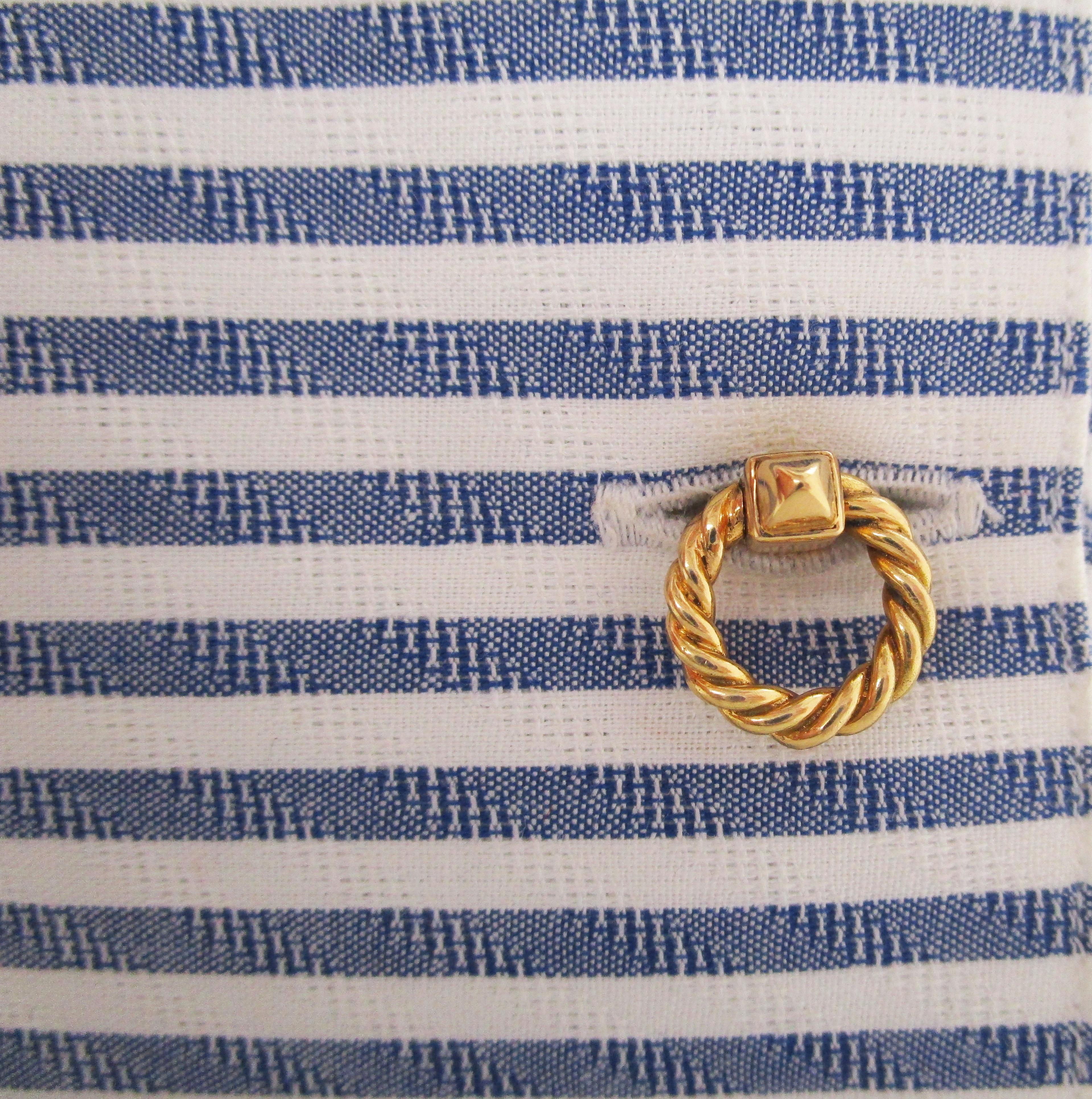 These incredible cufflinks are genuine French Paris Cartier and feature a classic, elegant twisting rope design in rich 18k yellow gold. The definite sophistication of the simplicity of the Cartier design is clear. Every inch of these fine cufflinks